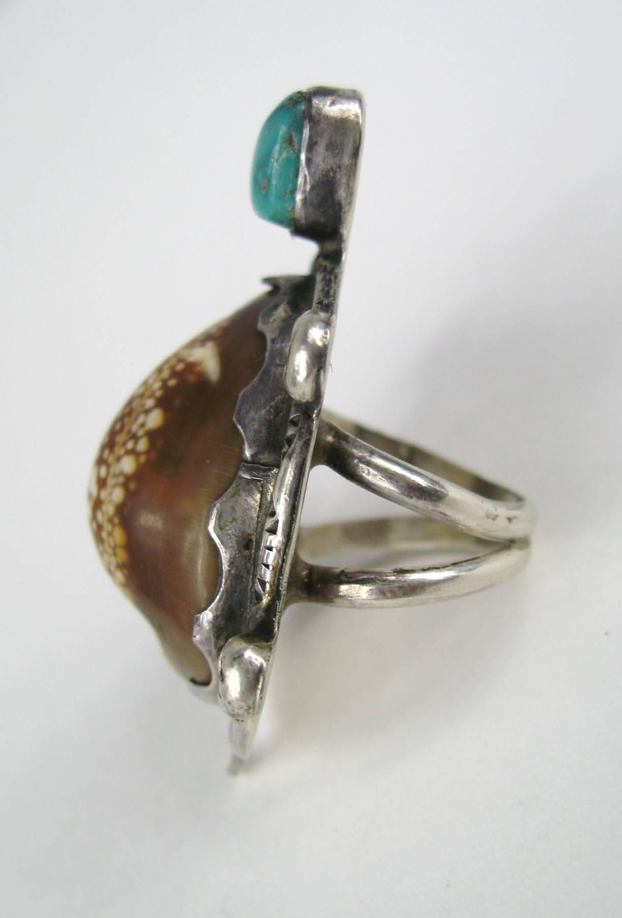 Another Fantastic piece from a E.A Zunie. The Matching Squash Blossom and Bracelet are available on our store front . Ring is a size 6. Measuring 1.90in x 1.30in. This is out of a massive collection of Hopi, Zuni, Navajo, Southwestern and sterling