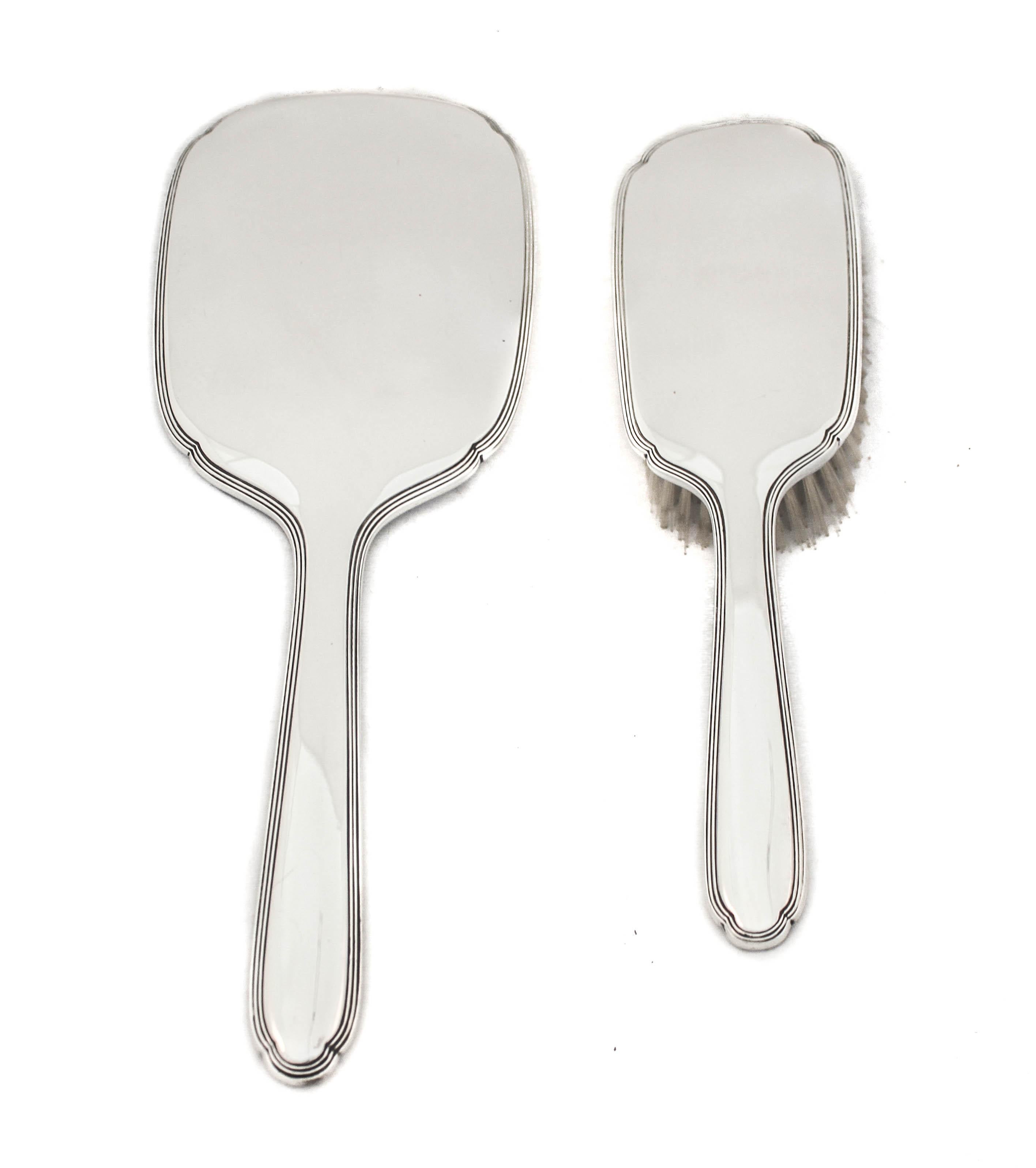 Being offered is a sterling silver (vanity) brush and mirror by R. Blackington & Company of Massachusetts.  It has a sleek and contemporary look that gives the impression it’s new but it’s not.  Three ridges follow the outline of each piece, other