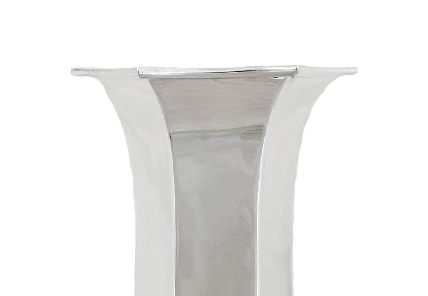 Proudly offering this gorgeous sterling silver vase from the early twentieth century by the Redlich Silver Company.  It has a striking shape with paneling— six panels in total and is complimented by a hexagon base.  Notice how graceful the shape of