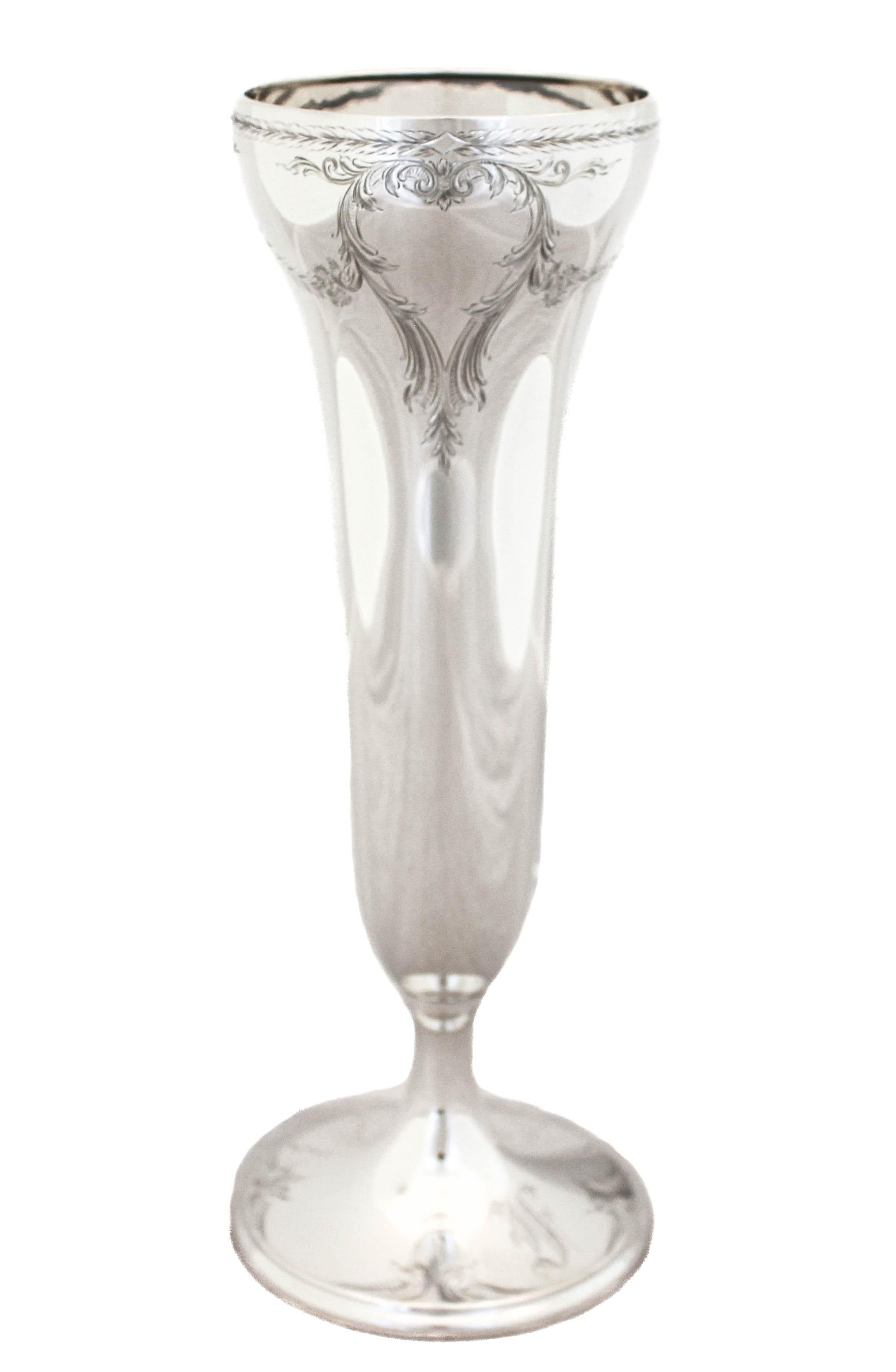 Being offered is a sterling silver vase by the Watson Silver Company. It has a delicately etched design around the top and again around the base. Wreaths, flowers and scrolls give this vase a feminine feel. On the base there is a hand engraved Old