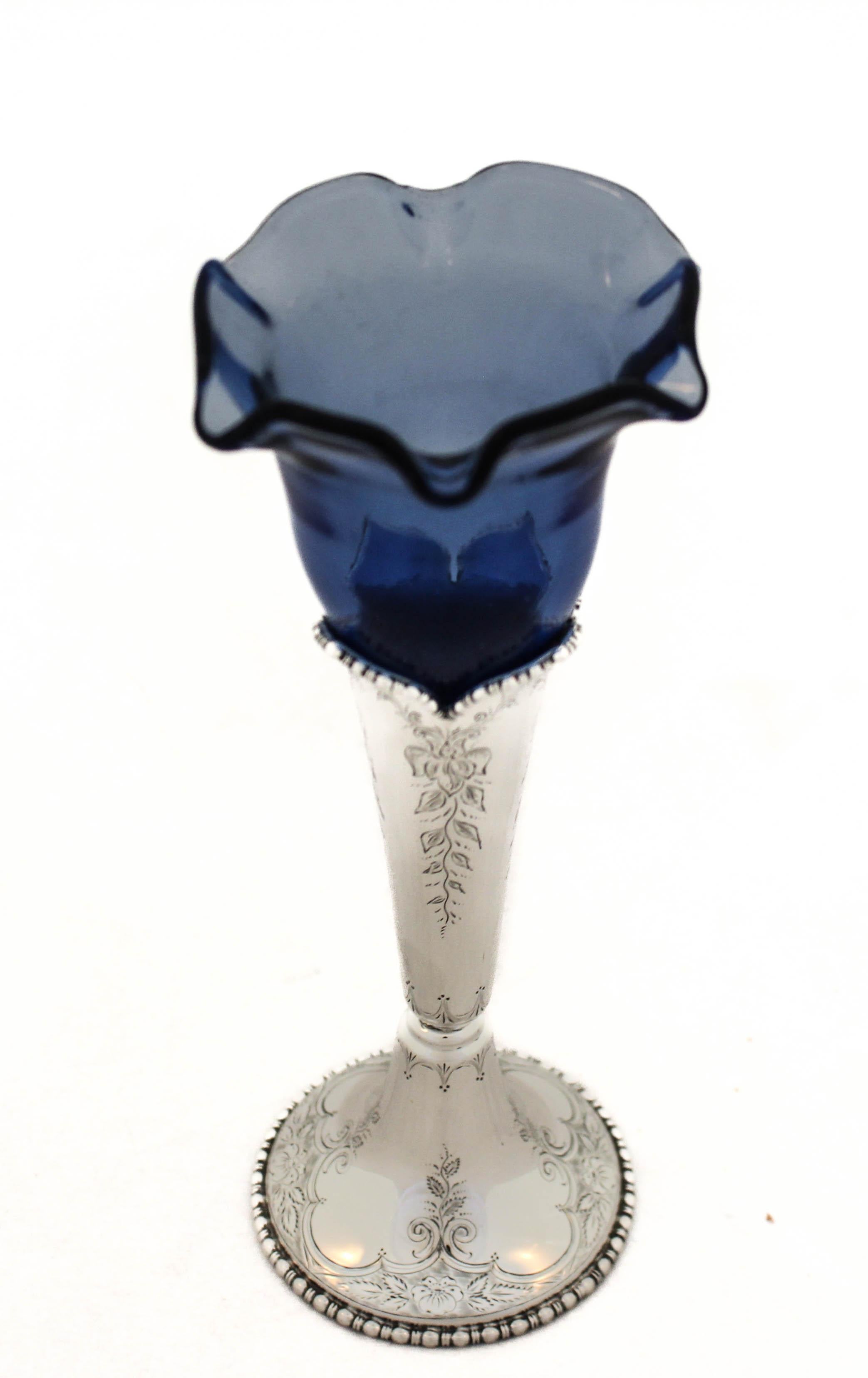 Being offered is a sterling silver vase by Black Starr and Frost with a glass liner.  The silver part has an etched design around the base as well as the body with a hand engraved script monogram in the center.  The blue glass liner is scalloped