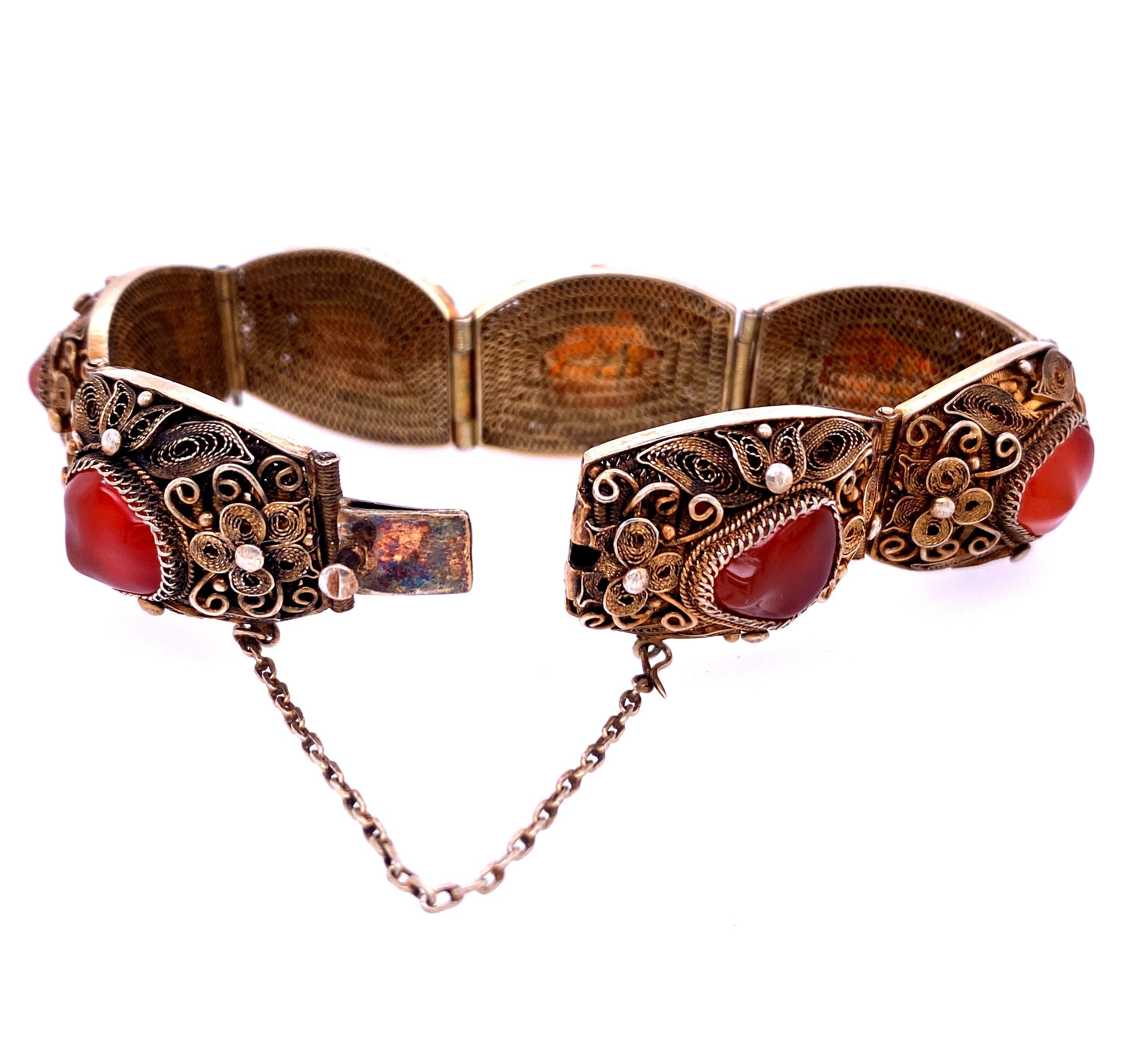 One sterling silver (stamped Z11 SILVER) filigree floral motif link bracelet  with cushion shaped links measures 26.5mm x 19mm set with carnelian nuggets measuring approximately 10.7mm x 9mm.  The bracelet measures 8 inches long and has a hidden box