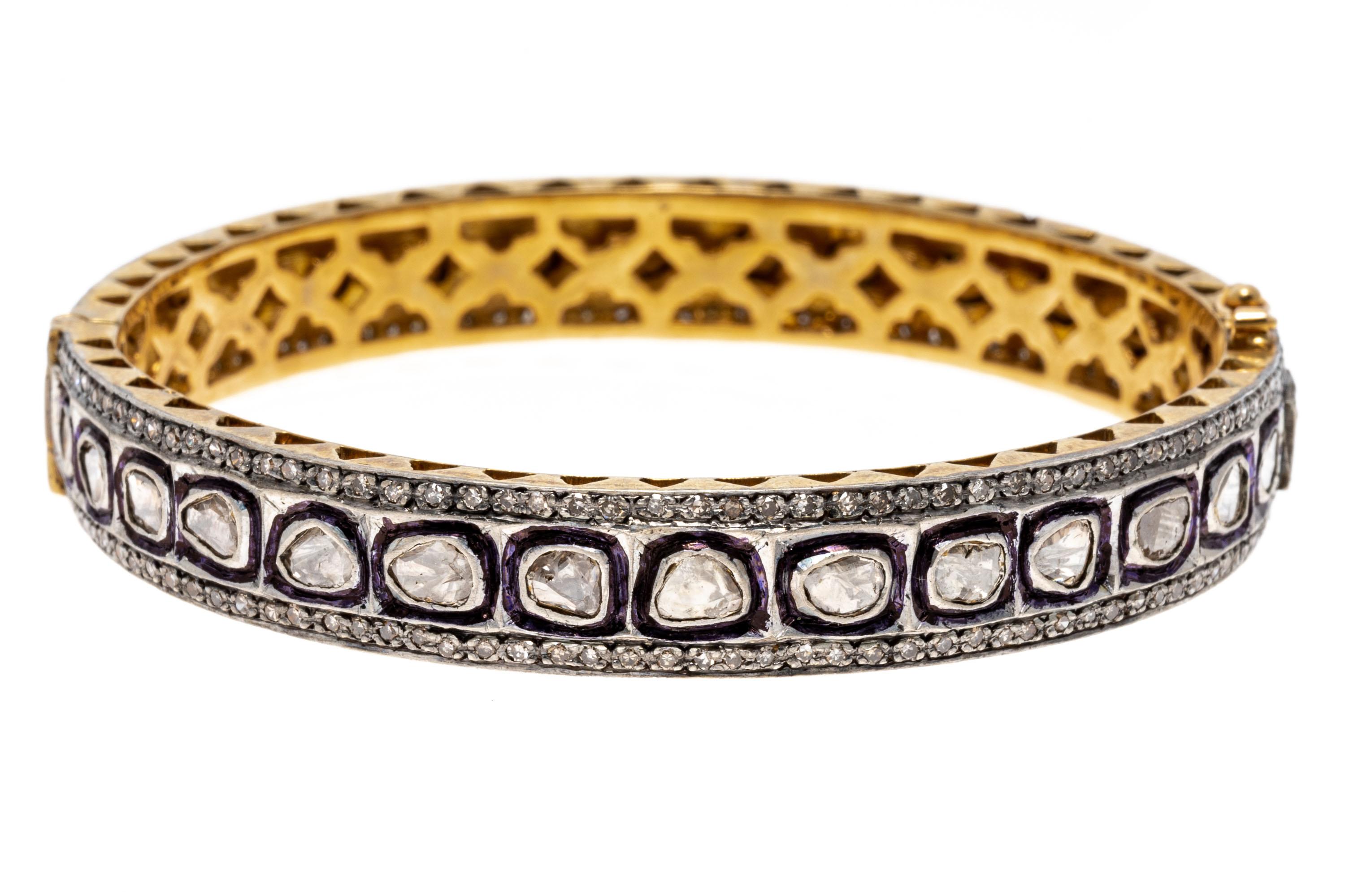 Sterling silver vermeil bracelet. This magnificent bracelet is a hinged bangle style, decorated in the center row with macle cut diamonds, bezel set. Framing the center on either side is a row of round faceted diamonds, approximately 0.55 TCW. The