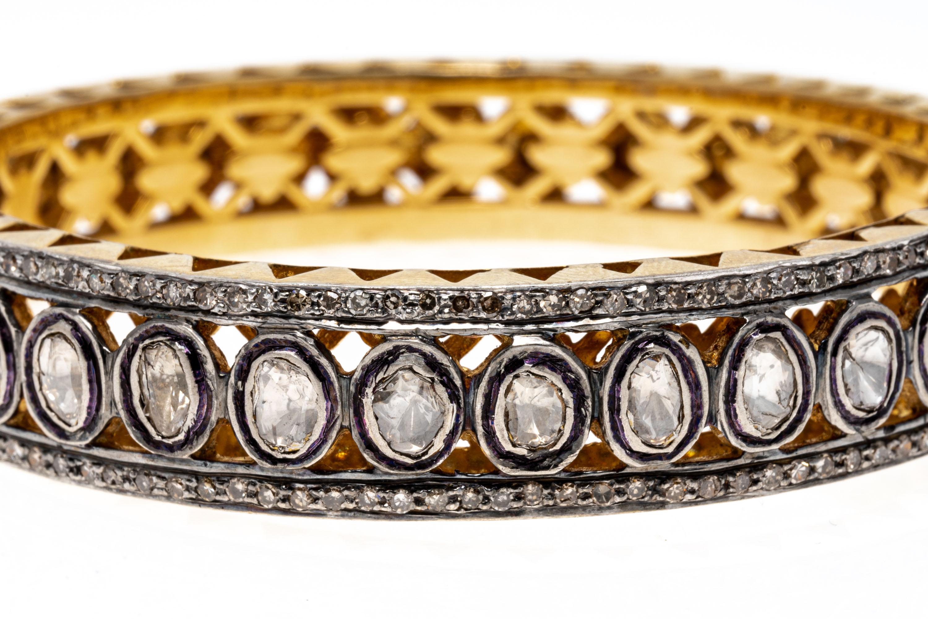 Sterling silver vermeil bracelet. This stunning bracelet is a hinged bangle style, decorated in the center row with macle cut diamonds, bezel set. Framing the center on either side is a row of round faceted diamonds, approximately 1.10 TCW. The