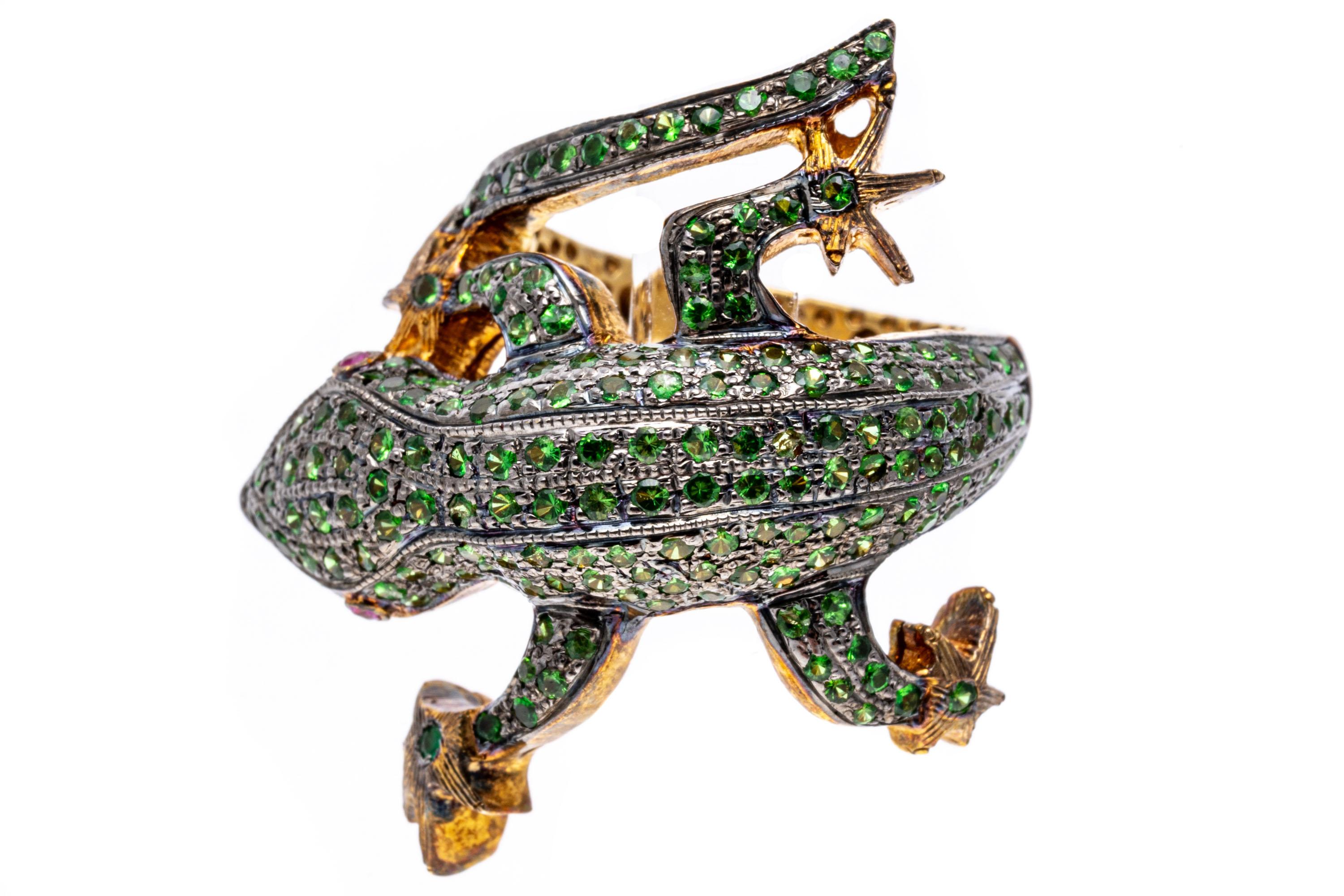 Sterling silver ring. This striking sterling vermeil bypass ring is a figural lizard, with the head on one side offset from the tail,  pave set with round faceted, green tsavorite garnets, approximately 1.87 TCW. The ring is finished by round