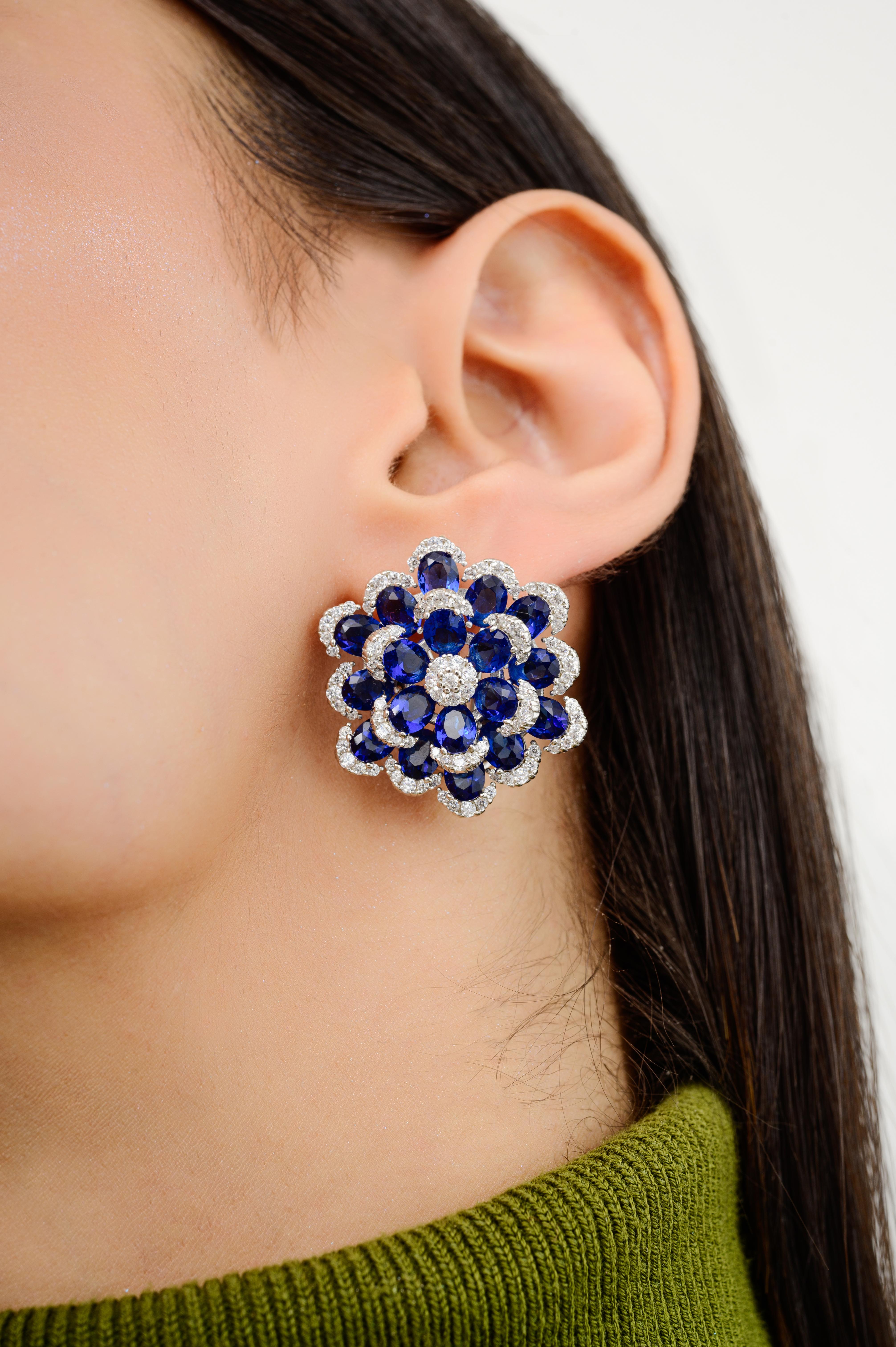Vibrant Blue Color Zircon Floral Stud Earrings Fashion Jewelry in sterling silver. You shall need these statement stud earrings to make a statement with your look. Each piece features dazzling cubic zirconia stones, renowned for their brilliance and