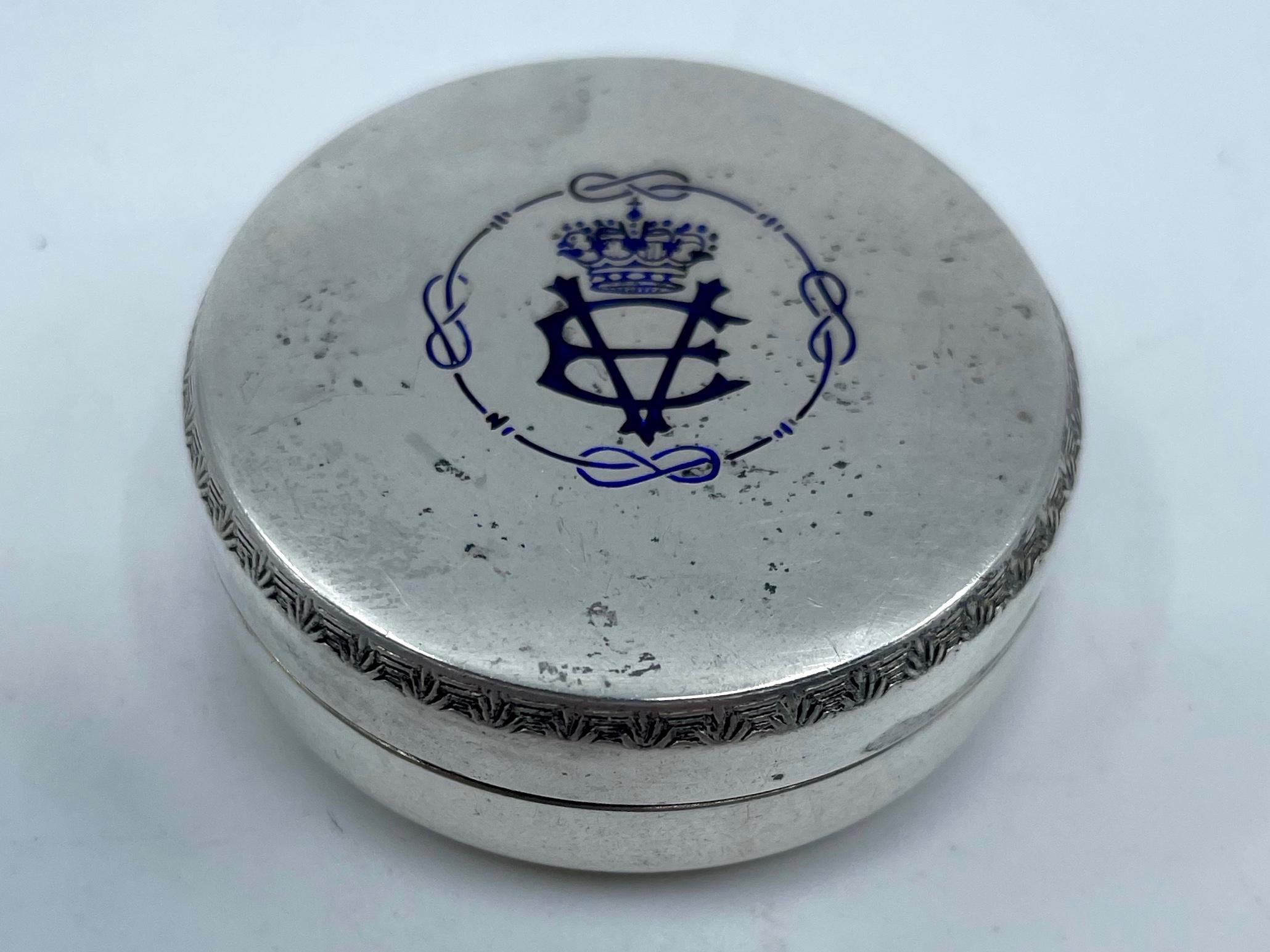 Sterling silver Victor Emanuel pill box. Antique blue enameled silver pill box with the crowned initials of King Victor Emanuel and House of Savoy rope emblem, stamped Masenza Rome. Early 20th century
Dimensions: 1.63” Diameter x .63