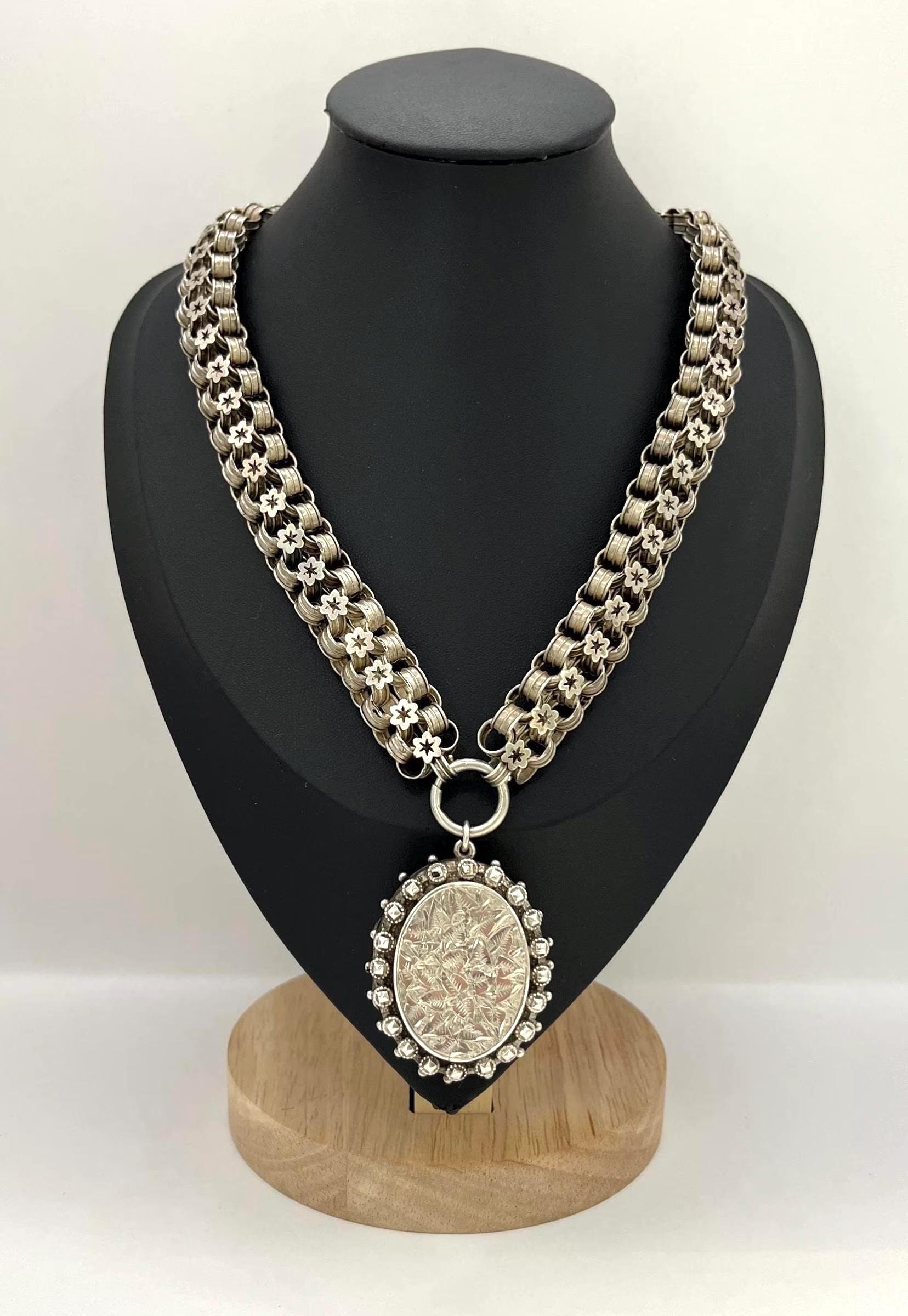 Collana a catena e medaglione con libro antico

Argento 

Marchio Birmingham 1882

Un bellissimo medaglione vittoriano e una catena a libro in argento sterling, con marchio Birmingham 1882. Il medaglione circolare presenta un disegno floreale