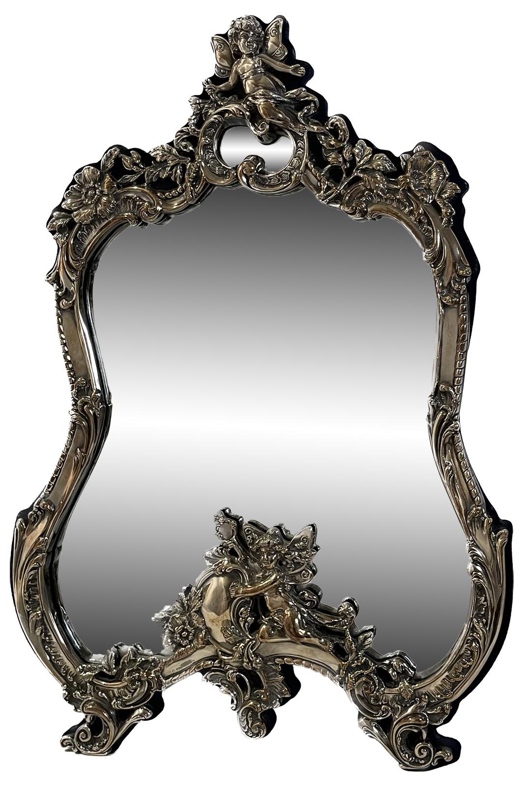 A sterling silver victorian style table mirror with cherubs and flowers. Marked 925 near the base.

Dimensions: 20.5