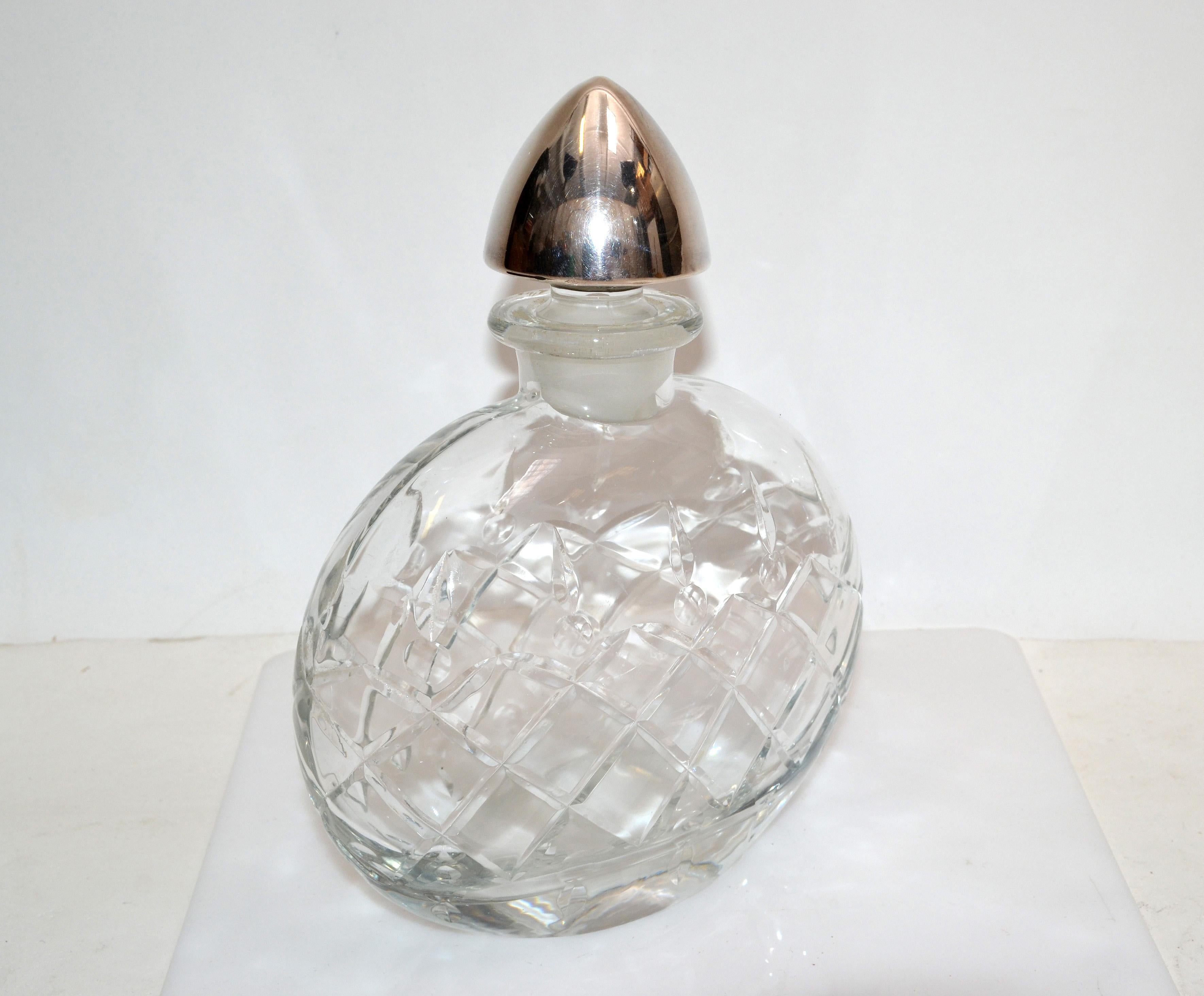 Vintage clear cut glass art glass perfume bottle with a sterling silver stopper.
Heavy perfume flacon marked at the stopper with symbols and sterling.
Beautiful for your Boudoir.
 