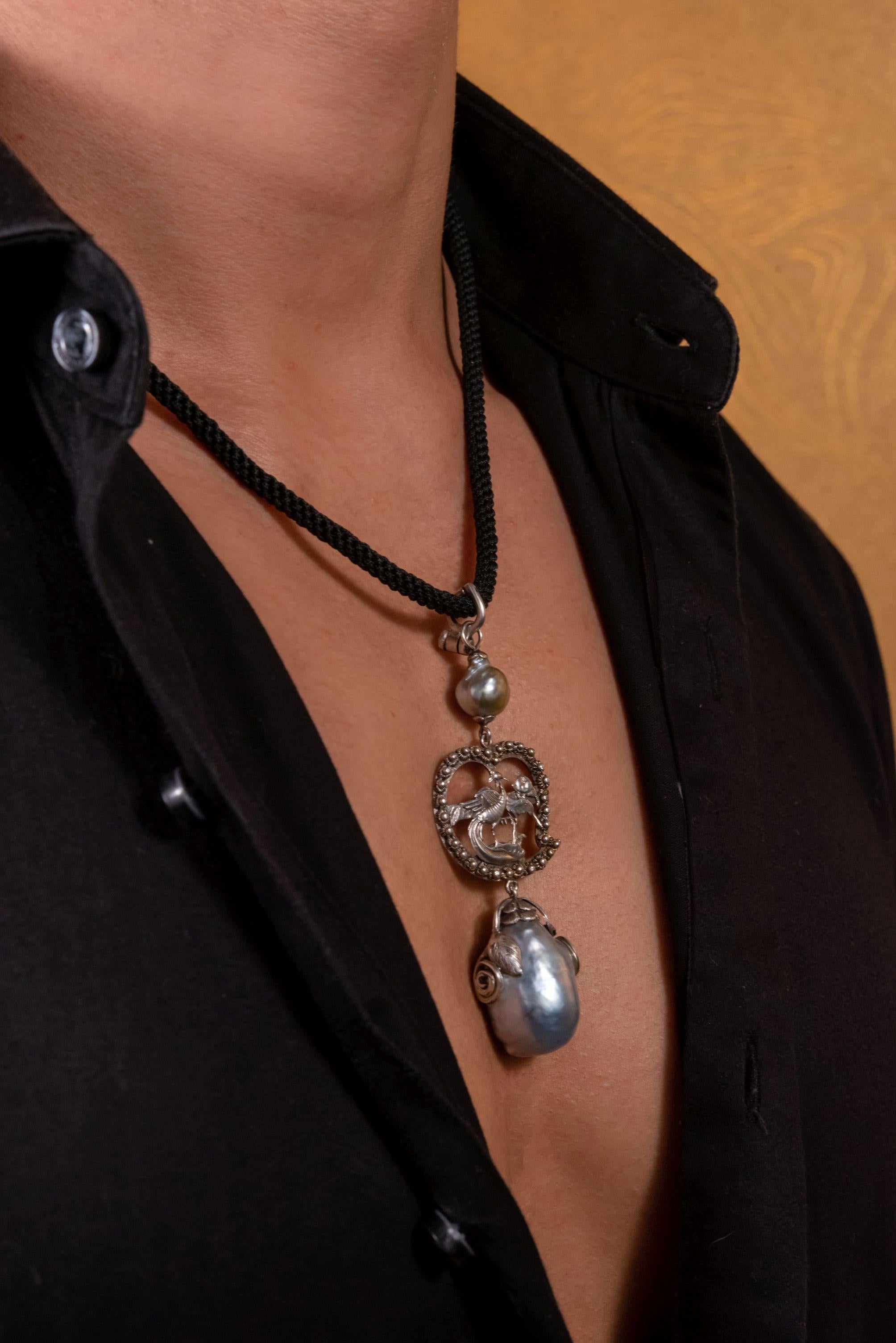 Rise from the ashes in style with our vintage Chinese phoenix pendant necklace. The ultimate symbol of hope and rebirth, this stunning phoenix pendant sits between two statement baroque south sea pearls. With intricate detail and a black woven