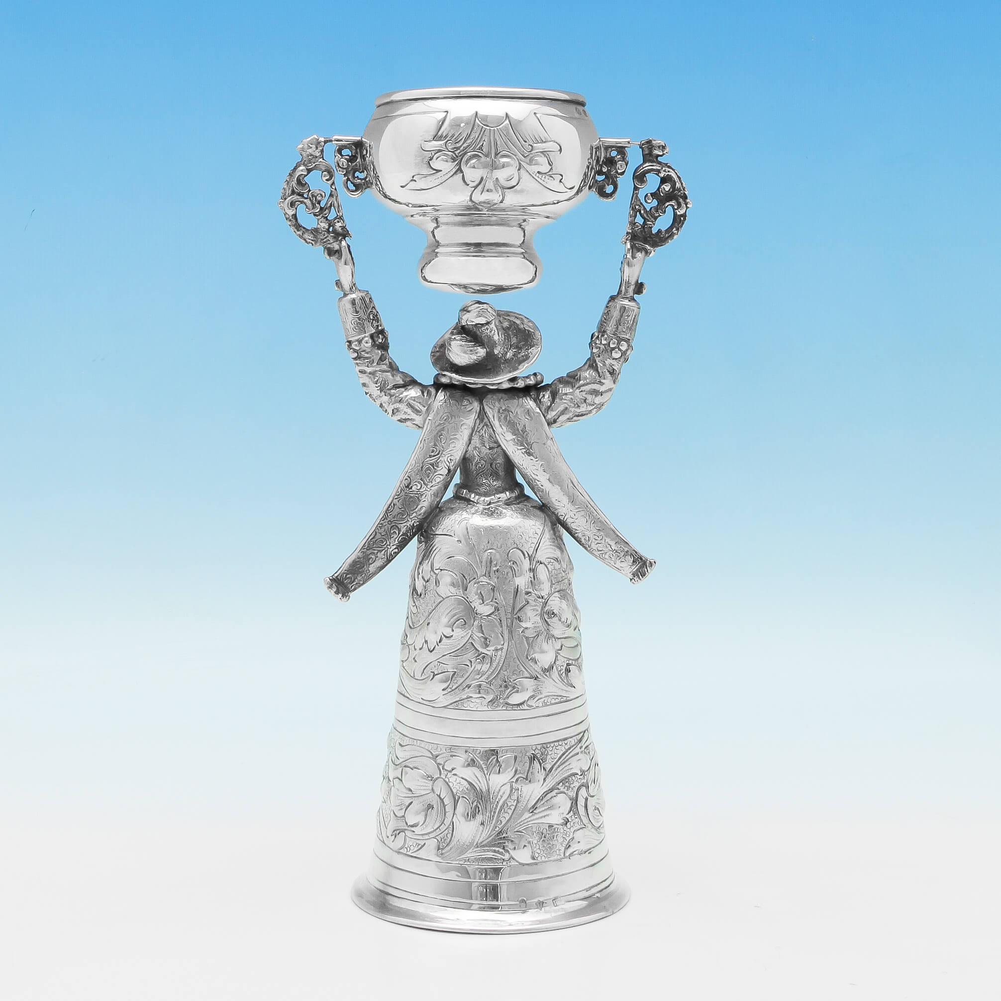 Carrying import marks for London in 1911 by Berthold Muller, this charming, Antique, Sterling Silver Wager Cup, is modelled as a bearded man in drag, with his skirt forming the larger cup. The wager cup measures 9