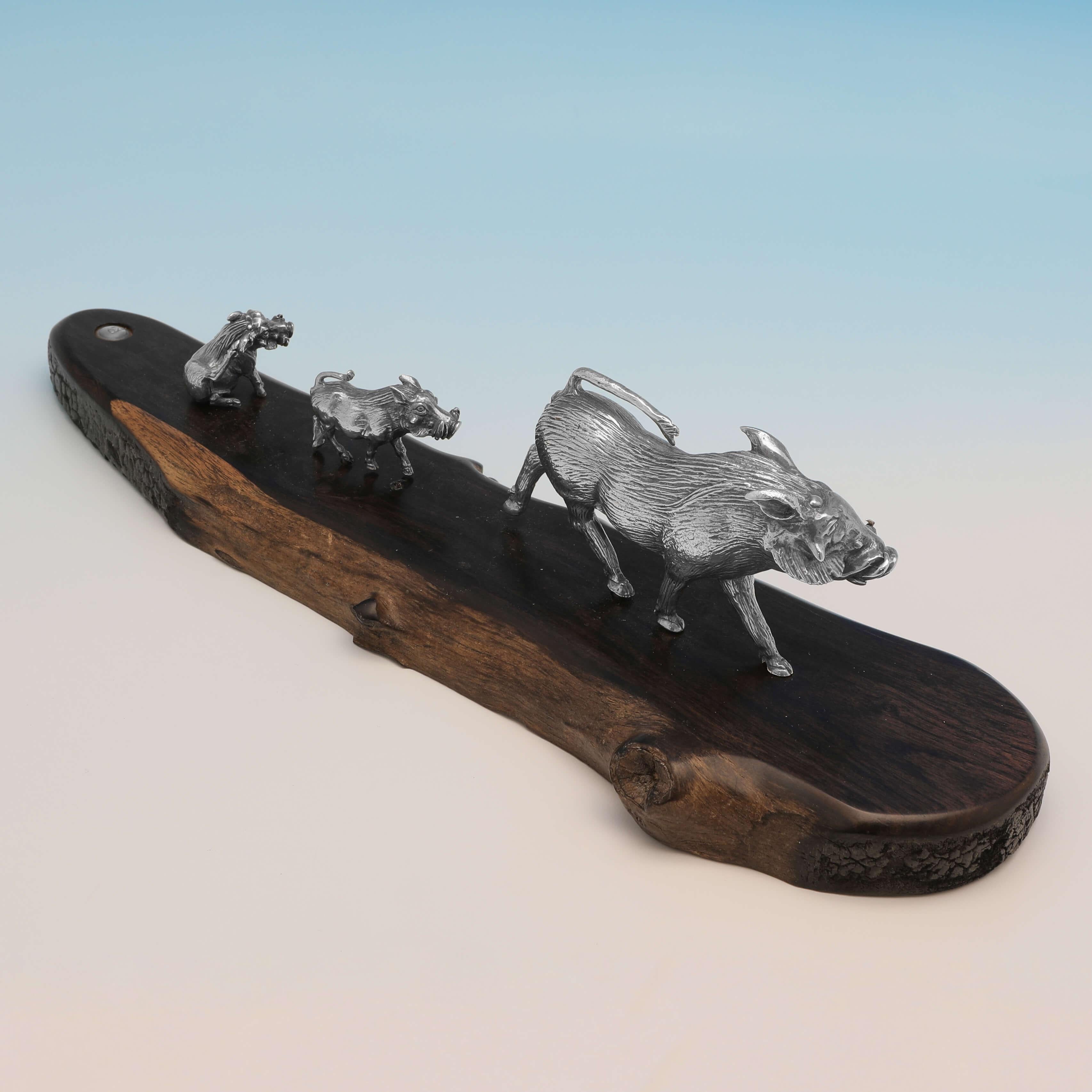 Made circa 2000 by Patrick Mavros, this charming, Sterling Silver Model of a Warthog Family, stands on wooden base, and in total measures 2.5