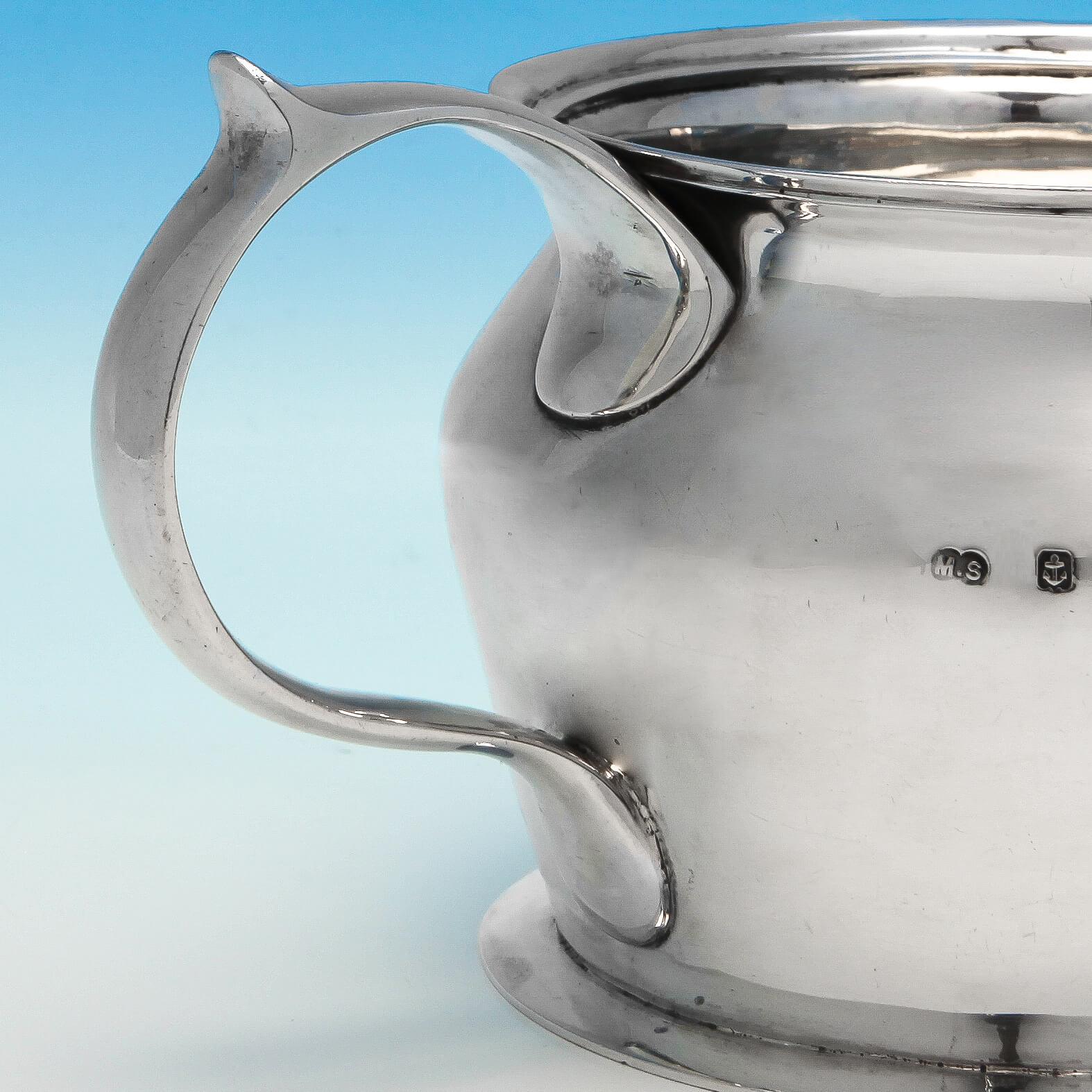 Hallmarked in Birmingham in 1911 by Duchess Millicent Sutherland, and made by the Duchess of Sutherlands Cripples Guild, this handsome, and very rare, antique, sterling silver milk jug is a fine example of Arts & Crafts style, with a scroll handle