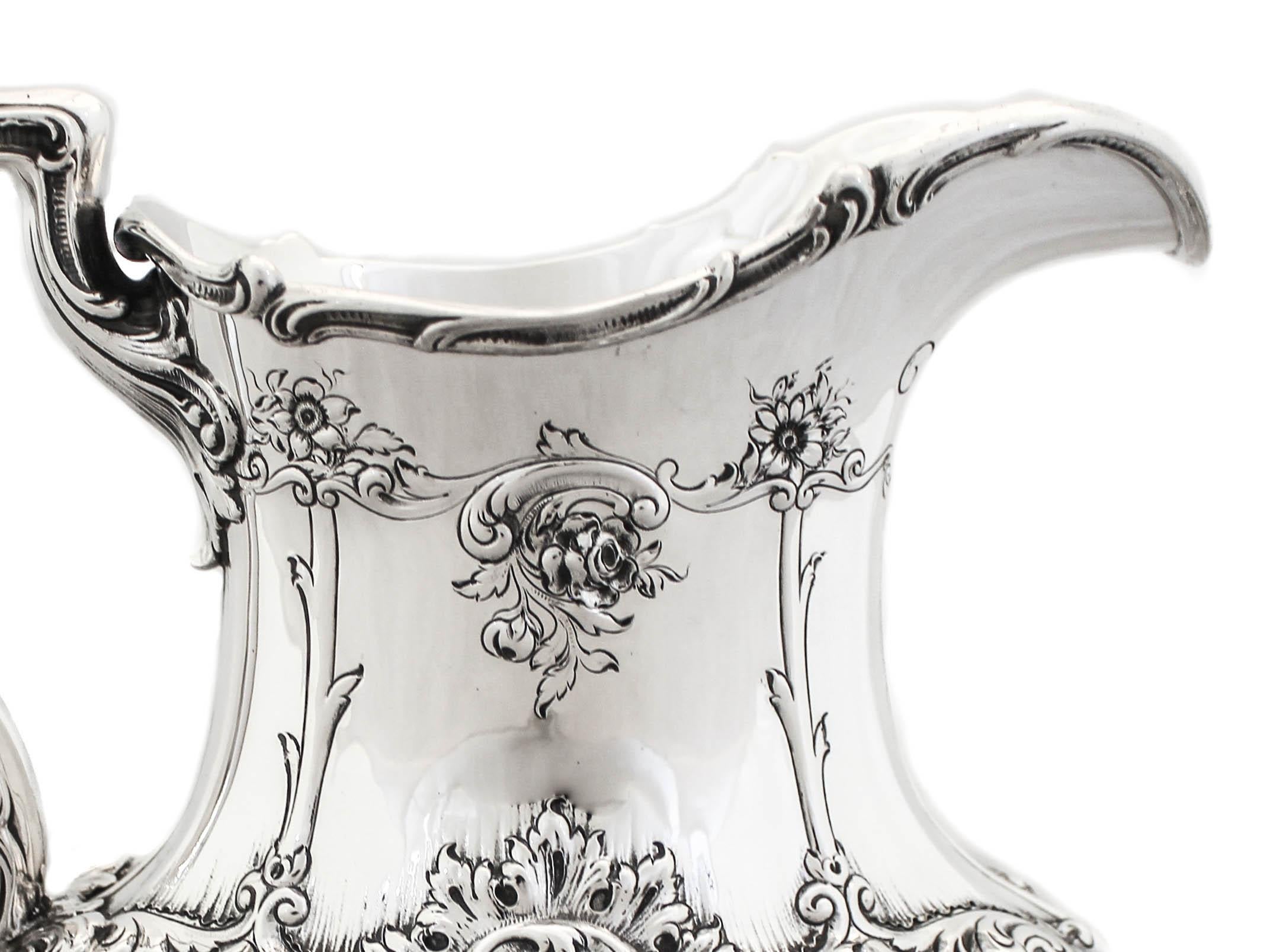 This magnificent & regal sterling silver water pitcher made by Gorham Silversmiths, is hallmarked 1915. The floral motif, the swirls and fluting along the rim…the workmanship and attention to every detail is simply breathtaking. Also the fact that