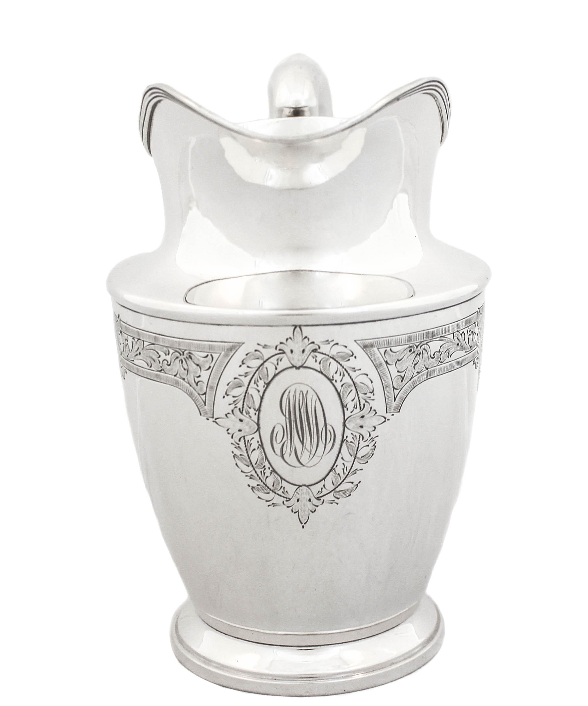 We are delighted to offer you this sterling silver water pitcher by the Schofield Silver Co of Baltimore, Maryland. It is a very impressive large piece that has a lot of presence. Sleek with just an etched floral motif going around the
upper-half.