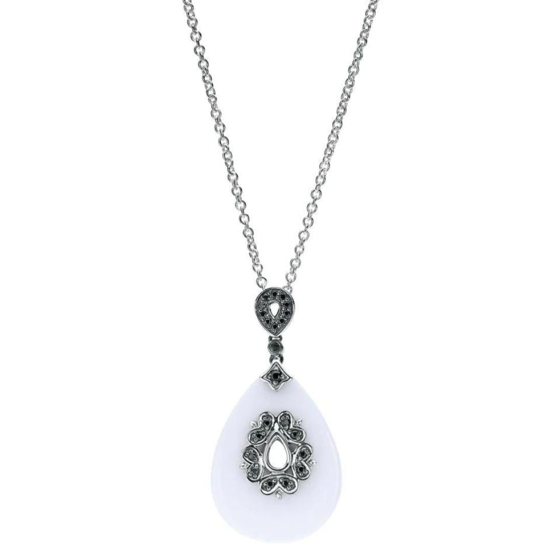 Sterling Silver, White Agate, and Black Spinel Pendant. Elegant and classy, this pear shaped drop pendant features almost 8 carats of genuine white agate, encrusted with black spinel weighing 0.15 ctw. Chain is 18