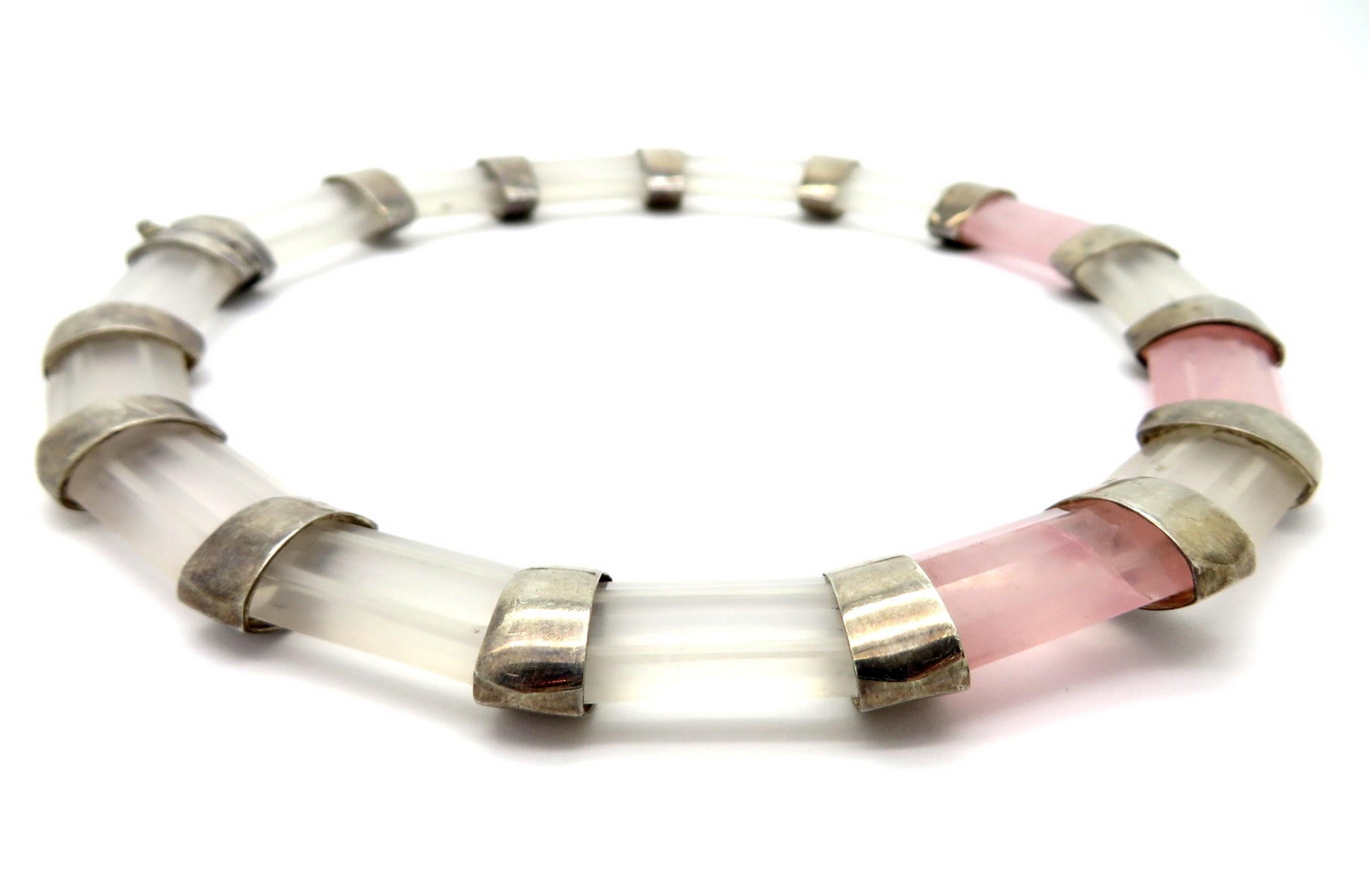 Sterling silver white and rose quartz fashion statement choker necklace. Featuring 12 faceted white quartz gemstones and three rose quartz gemstones. It is secured with a fold over clasp. The necklace measures 16” inches long and 18 mm wide. The