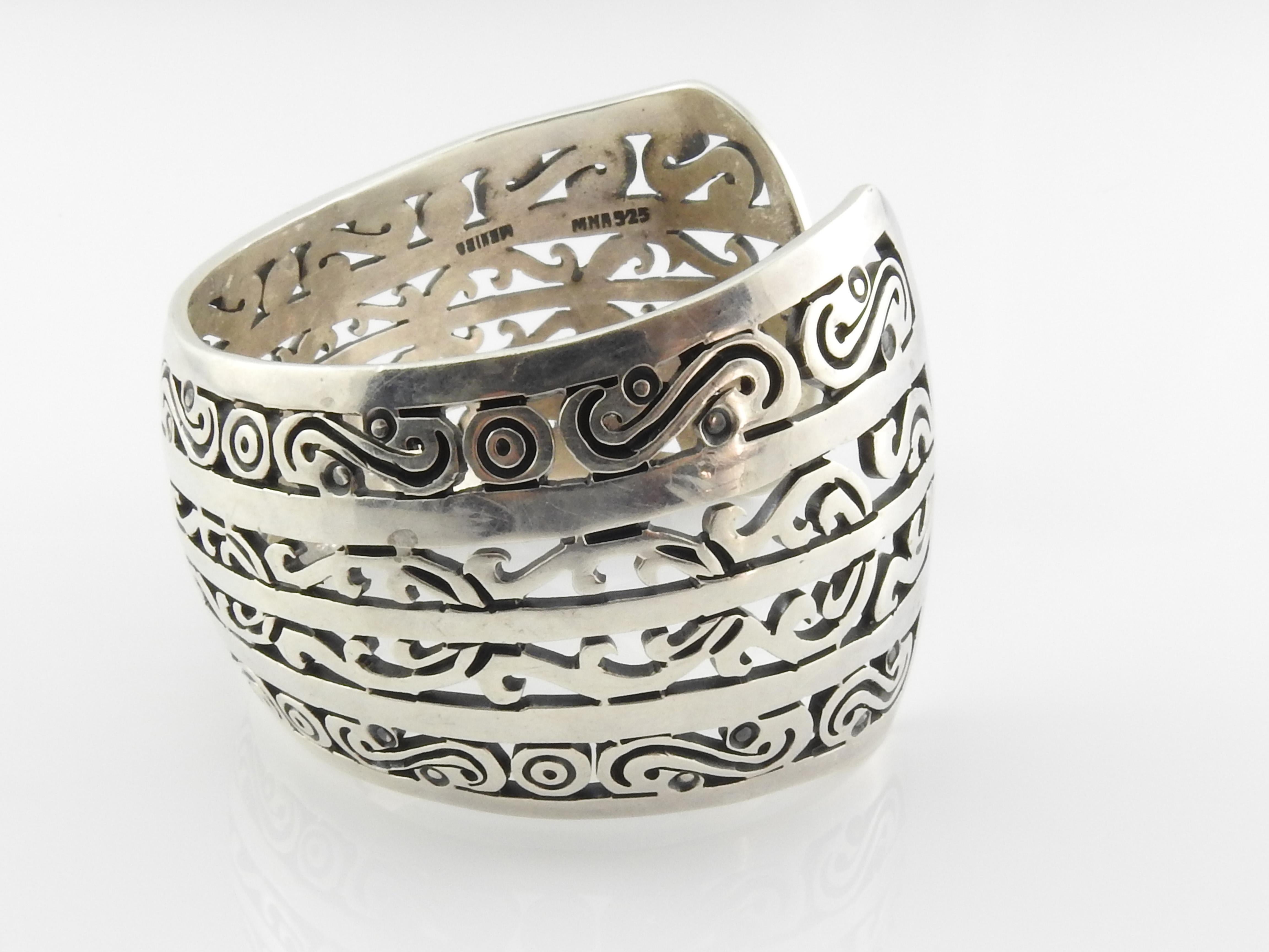 MMA Mexico sterling silver wide cuff bracelet with a cut-out scroll design.

Marked: MMA 925 MEXICO

Measures: 7