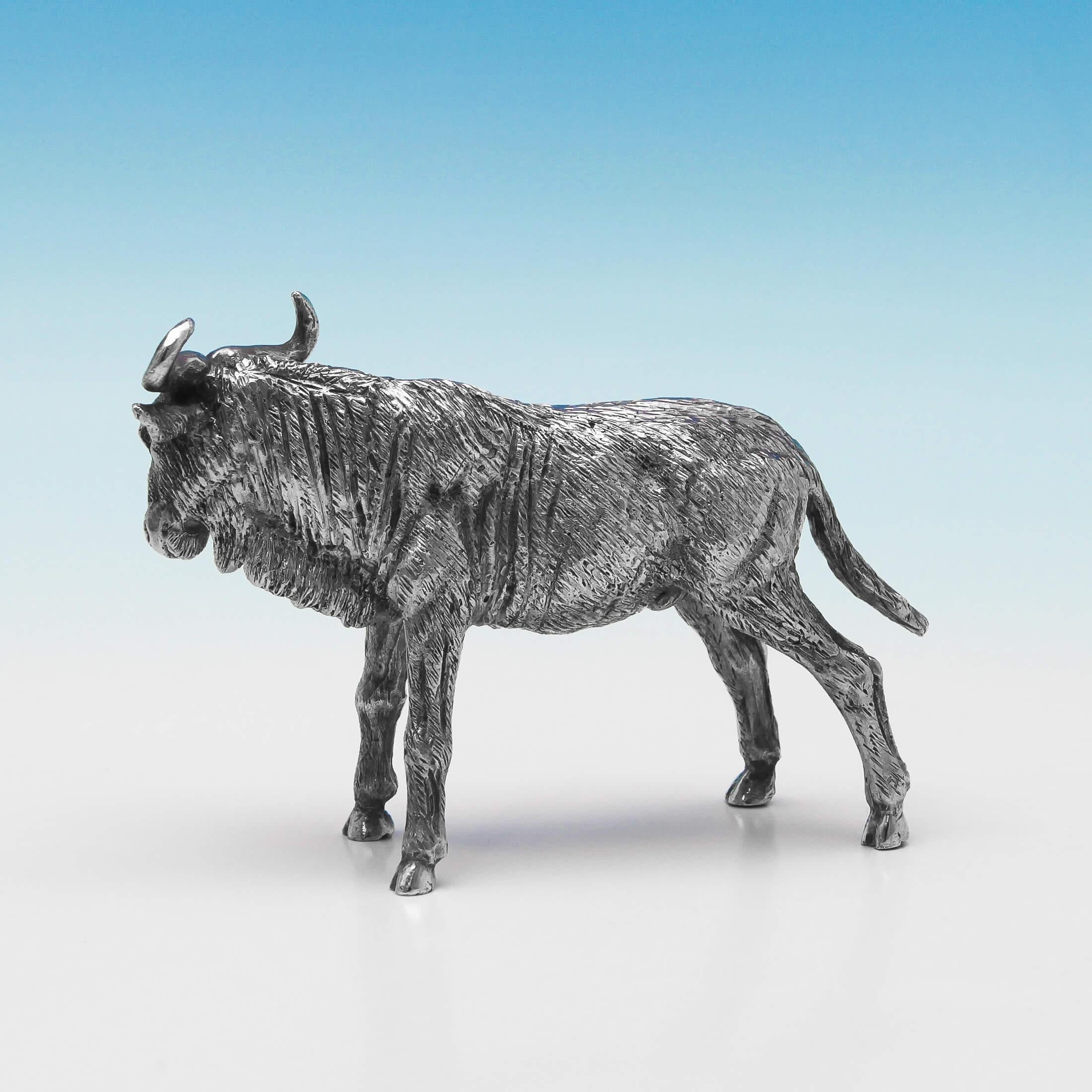 Hallmarked in London, in 2003, this handsome, sterling silver model of a wildebeest, is realistically cast, and measures: 3 inches (7.5cm) tall, by 4.75 inches (12cm) from nose to tail. The wildebeest (or gnu) weighs 14.2 troy ounces.
  