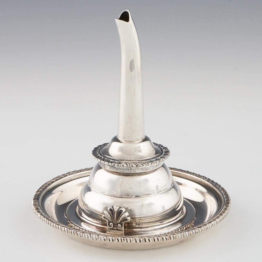 Heading : A sterling silver wine funnel and stand
Date : Hallmarked in London 2000
Period : Elizabeth II
Origin : London England
Decoration : Pie-crust borders and acanthus leaf clip. Parcel gilt interior
Size :  The wine funnel height 13.2cm and
