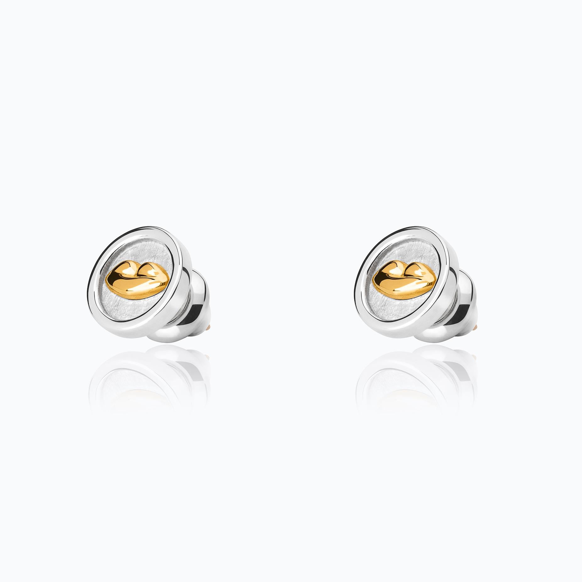 The Bésame Medal Vermeil Earrings from the Bésame collection by TANE are made in sterling silver with 23 karat yellow gold vermeil. At the center of each medal-shaped earring, the collection's signature kiss emerges in relief, framed by a polished