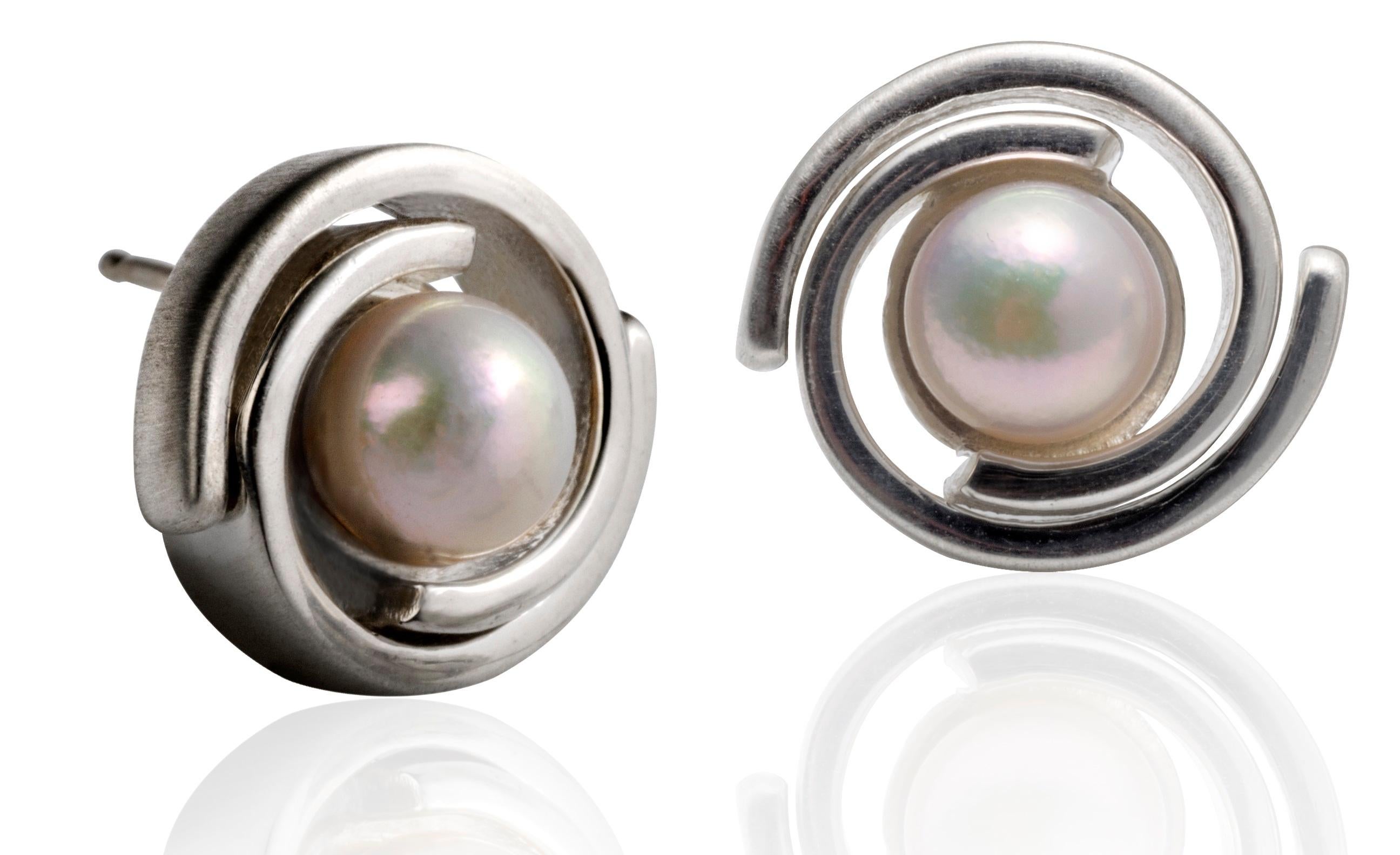 This simple 925 sterling silver stud, is set with a pair of lustrous blue grey Akoya pearls. The earrings are hand finished with satin sides and high polish top. These Double Spiral post earrings are part of the Orbit collection.  (There is nothing
