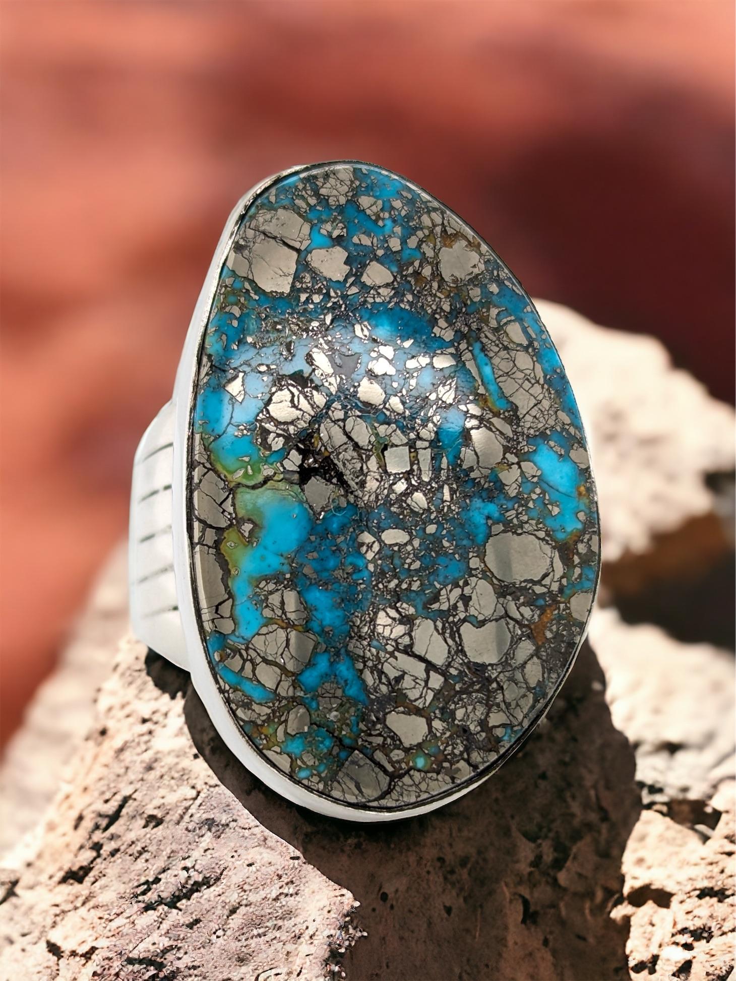 Embrace timeless elegance with this captivating Size 12 Sterling Silver Ring. Featuring a genuine American turquoise gemstone, this piece adds a touch of natural beauty to any outfit.

A Touch of Americana: The vibrant colors of the American