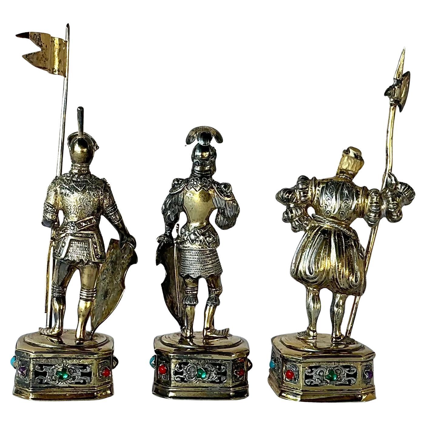 Early 20th Century Sterling Silver with Gold Wash Historical Knight Figurines, likely German ,Set of Three. Each depicts an iconic medieval warrior . Modeled in full armor with parcel-gilt accents, carved faces, and helmets featuring articulated