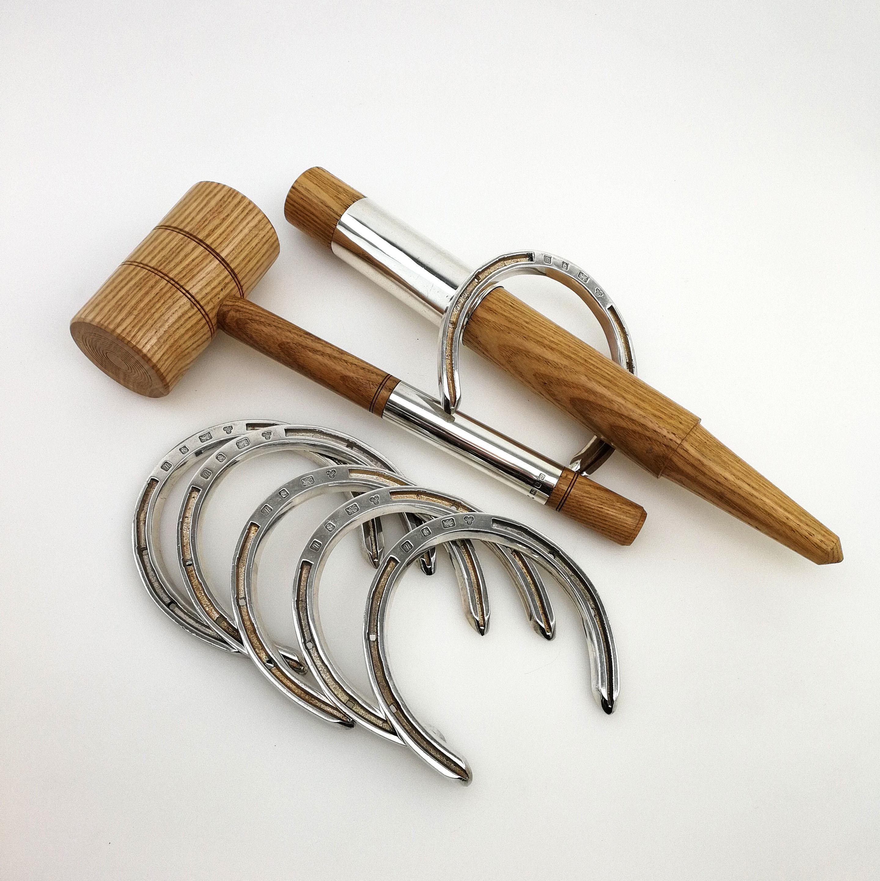 A rare and wonderful sterling Silver and Wood Horseshoes Set. This Traditional Game has been re-imagined in sterling Silver and Wood, with a set of 6 solid Silver Horse Shoes for Tossing, and a light wood Stake & Mallet each with a wide sterling