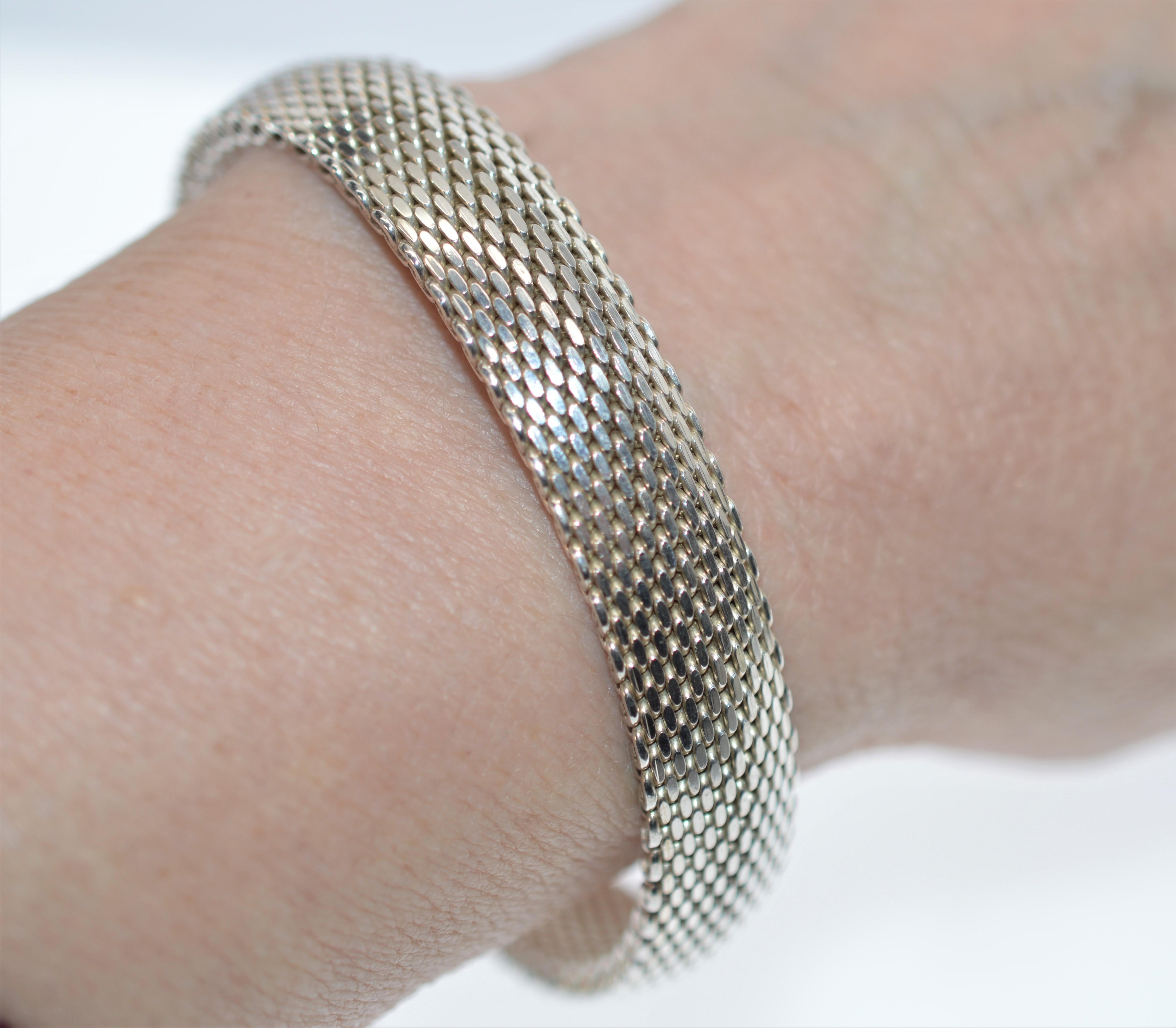 A sleek, modern look. Flexible and super comfortable to wear. Slips on and off, no clasps or catches and crafted one inch wide of woven Sterling Silver with a 2-1/2 inch diameter. In Gift Box.