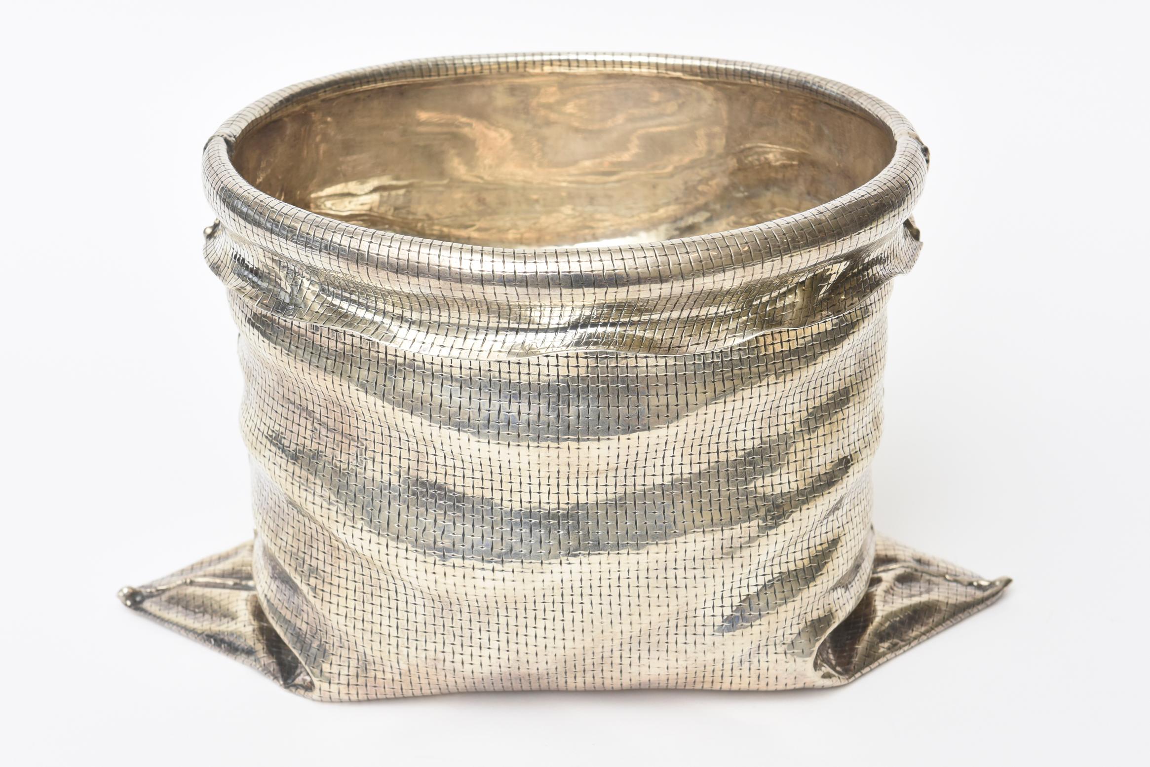 This beyond stunning Italian chased and woven sterling silver ice bucket champagne bucket and or vessel is sculptural and a beautiful conversation piece. It is folded and draped sterling silver. It is art in chased sterling silver. It is jeweler