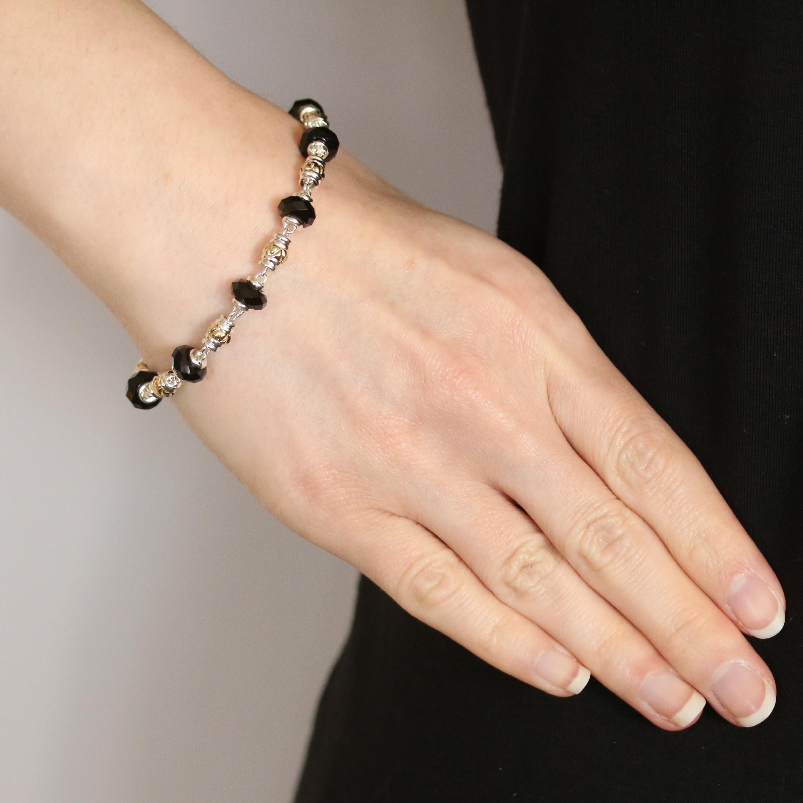 Metal Content: Sterling Silver & 14k Yellow Gold

Stone Information: 
Genuine Onyx
Cut: Rondelle Beads
Color: Black

Bracelet Style: Link
Closure Type: Spring Ring Clasp

Measurements: 
Length: 7 1/2