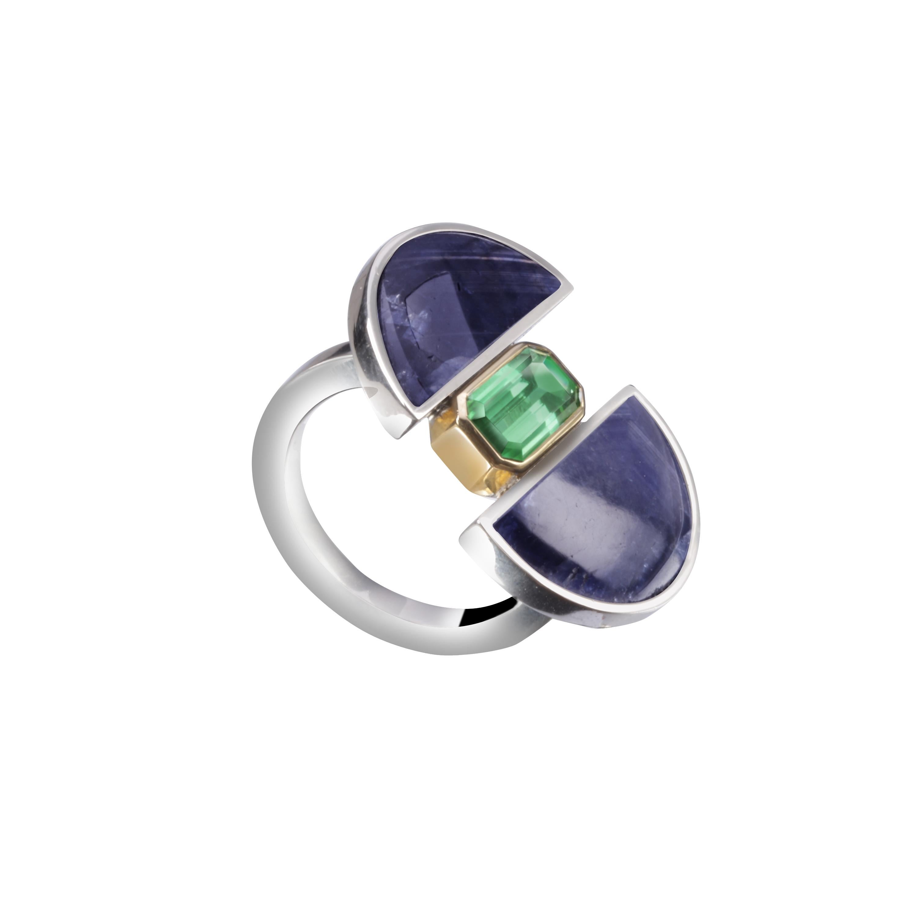 This ring is handmade in Sterling Silver and 18k yellow gold with two pieces of blue sapphire and a green tourmaline.
The main structure is made in silver, and the green tourmaline is surrounded by yellow gold, making a contrast.
It is a unique