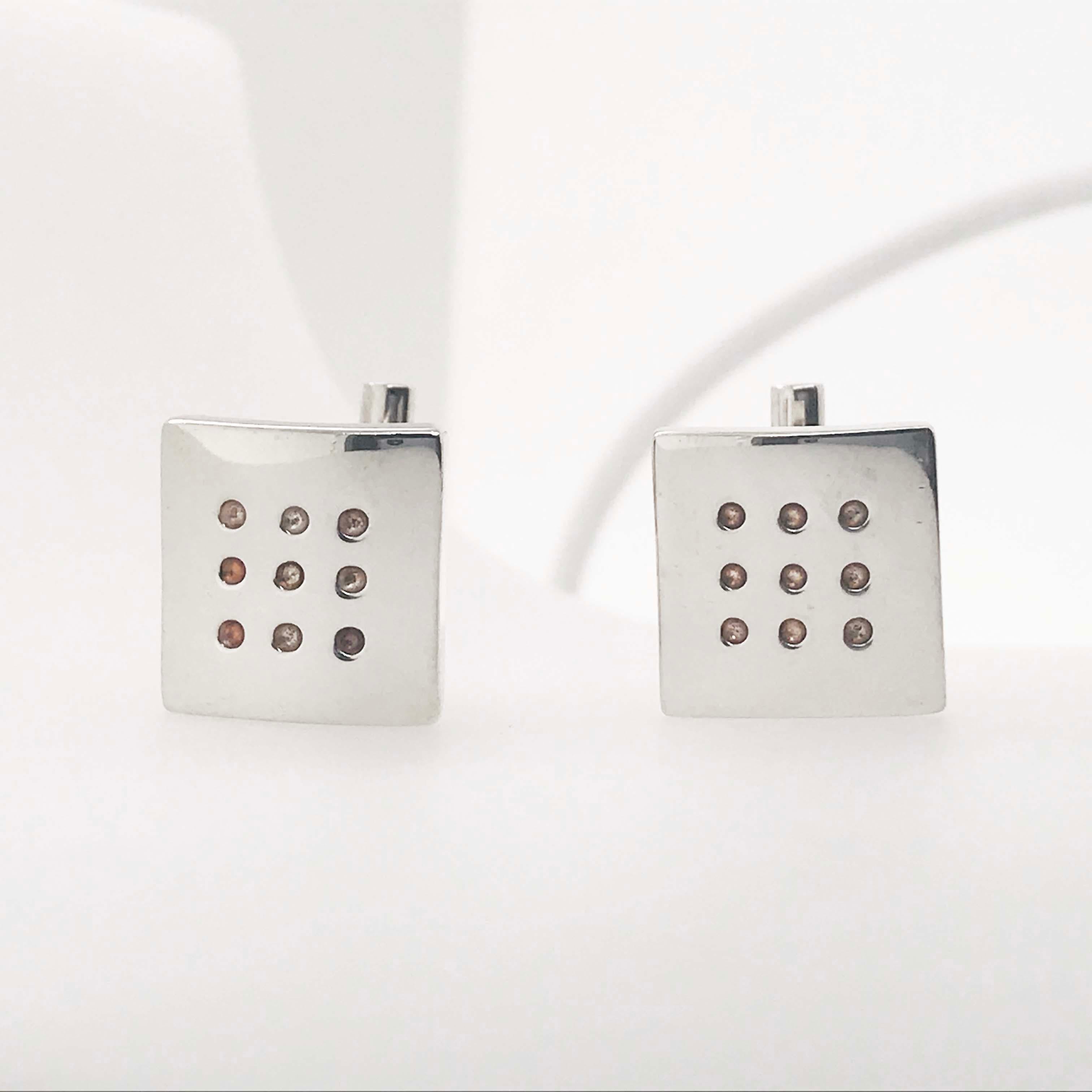 These sterling silver dice inspired cuff-links are stylish and modern! With nine round dots on a square shaped cuff-link. These men's cuff-links are versatile and go with any formal wear! The sterling silver cuff-links were carefully crafted and