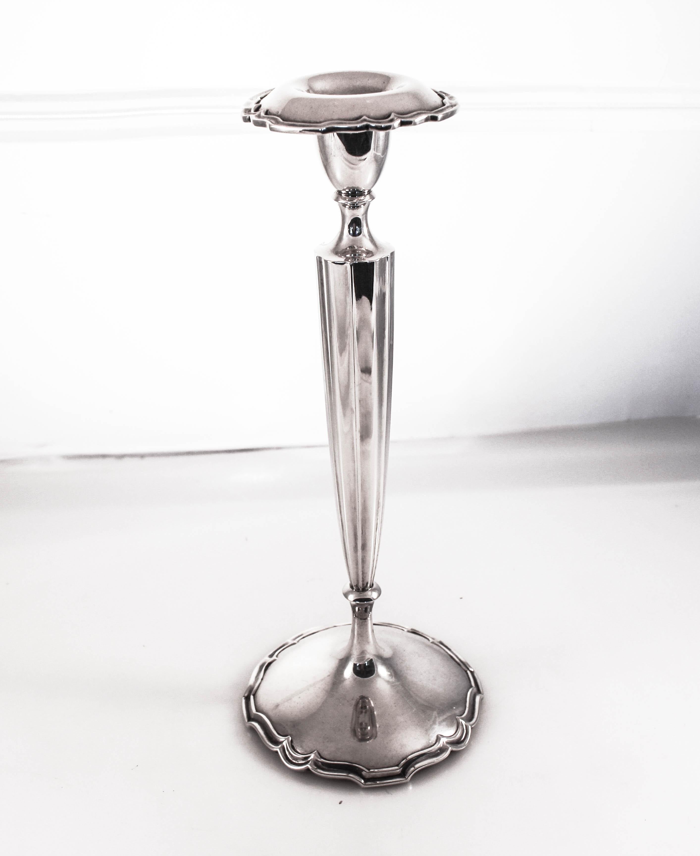 We are delighted to offer this pair of sterling silver candlesticks by Shreve & Company of San Francisco, California. They have a scalloped base, body and bobeche. They are exceptionally tall and have a presence. The bobeche are removable which