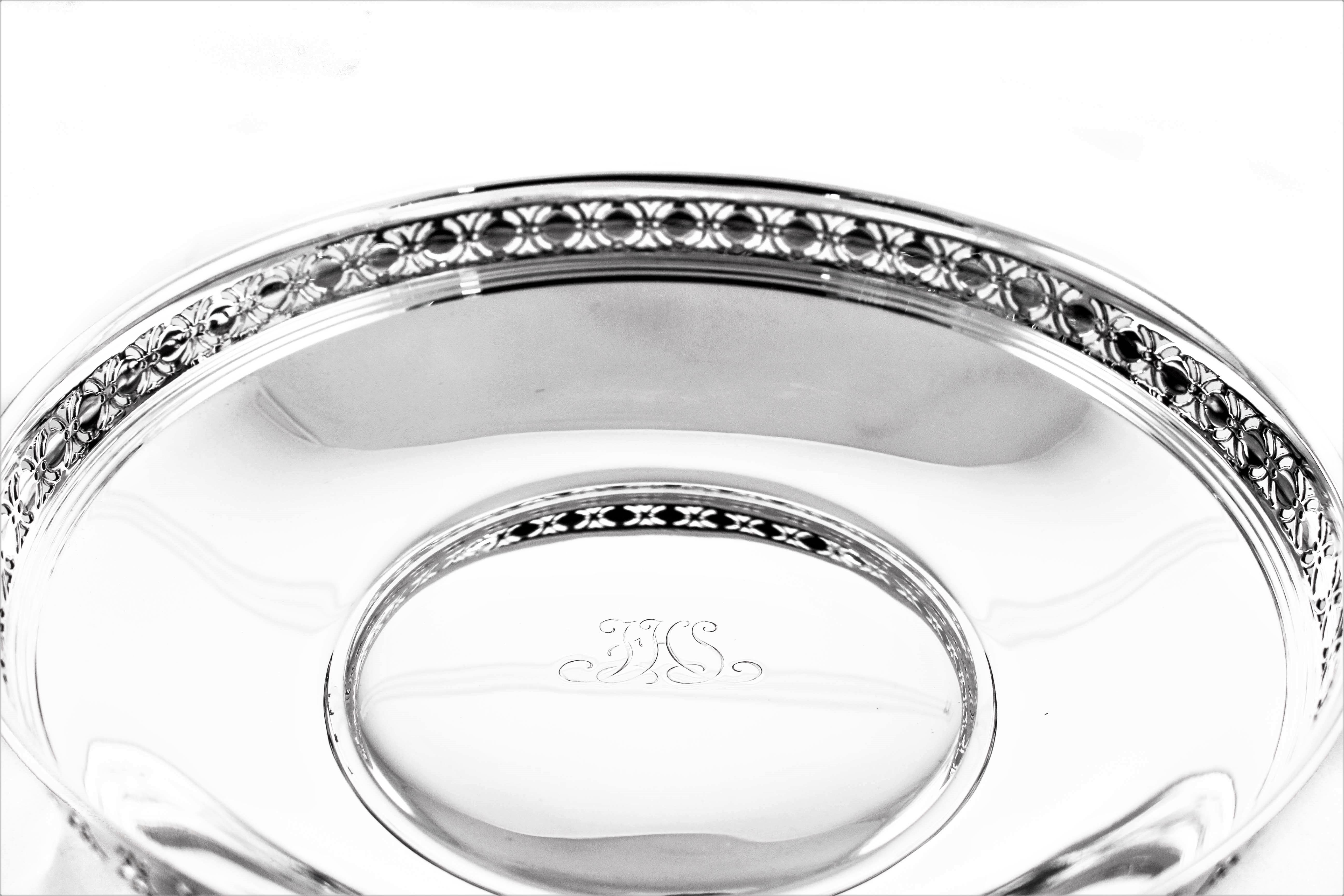 This reticulated bowl by Tiffany and Company has a cut-out design around the edge. It has a curved shape on the sides and nice depth. In the centre a hand engraved monogram in that distinctive Tiffany style.
    