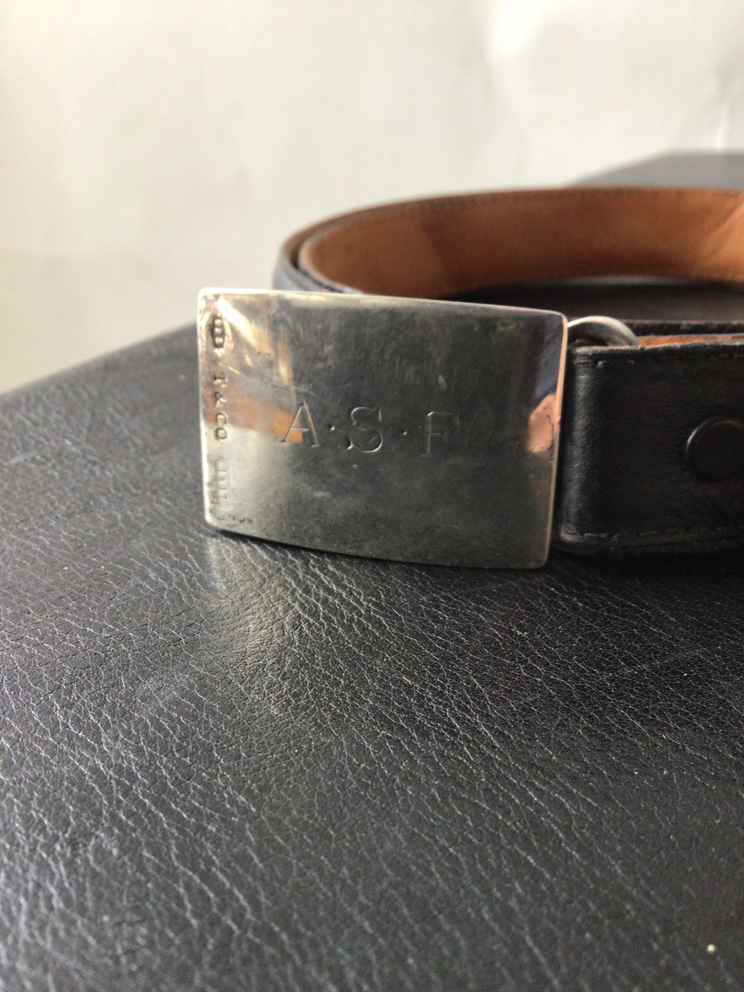 Tiffany sterling buckle on a black leather belt. Both marked Tiffany. Size 34.