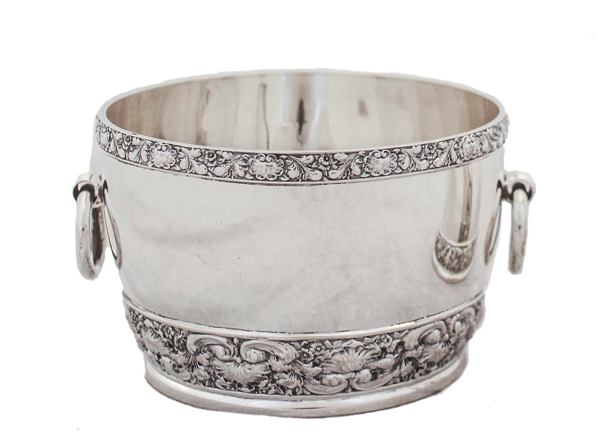 This lovely sterling silver cream and sugar set by the world renowned Tiffany & Company is being offered. The sugar bowl has handles on each side. Around the top rim and base a chased floral motif wraps around. The same design can be found on the