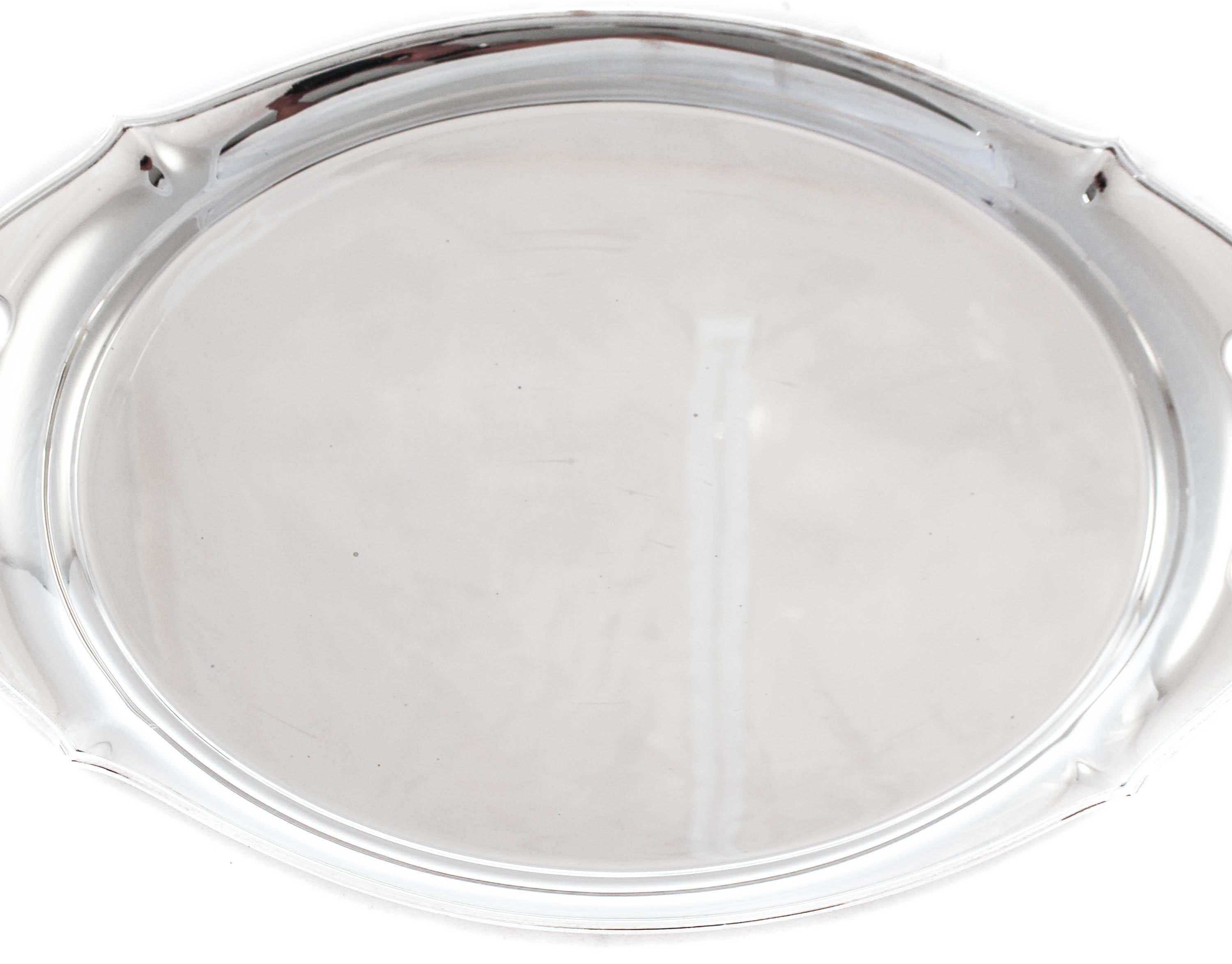We are thrilled to offer this sterling silver tray by the Gorham Silver Company of Rhode Island, signed 1917. One hundred and three years old, this beautiful tray has been privy to many a family dinner and holiday festivities. It has a scalloped rim