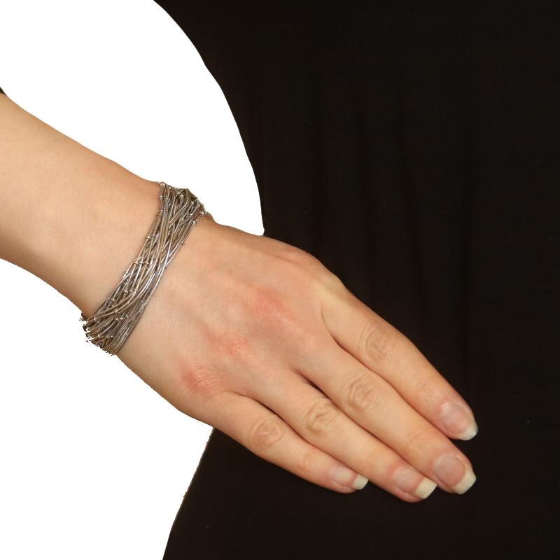 Metal Content: Sterling Silver

Style: Twenty-Six Strand
Chain Style: Snake & Fancy Snake
Bracelet Style: Chain
Fastening Type: Slide Clasp with Two Side Safety Clasps

Measurements

Length: 7 1/4
