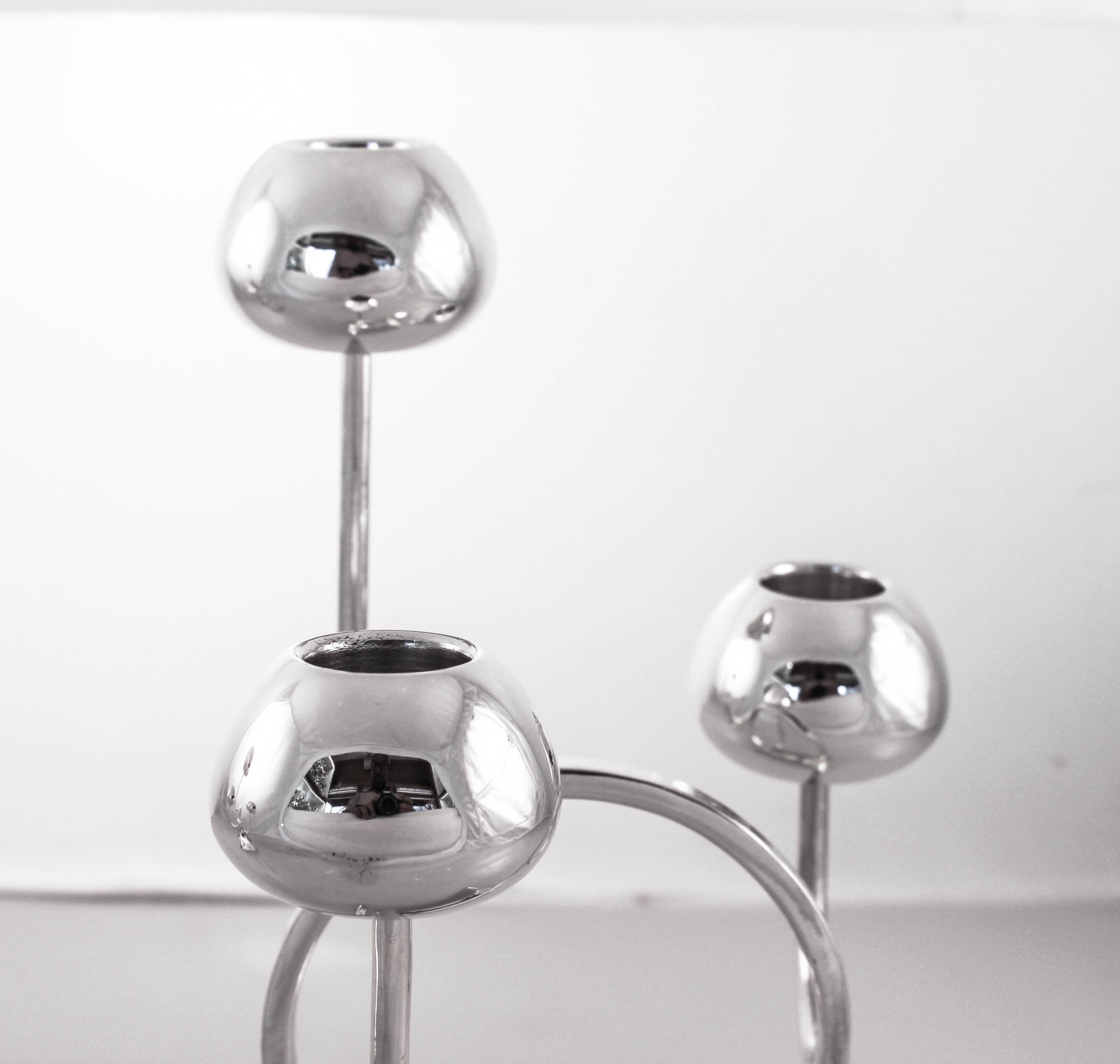 We are proud to offer this pair of three-branch sterling silver midcentury candelabras. They are uber-modern and futuristic. Different heights -10” and 7” and shapes— circular and square, make for an abstract decorative piece. They look like