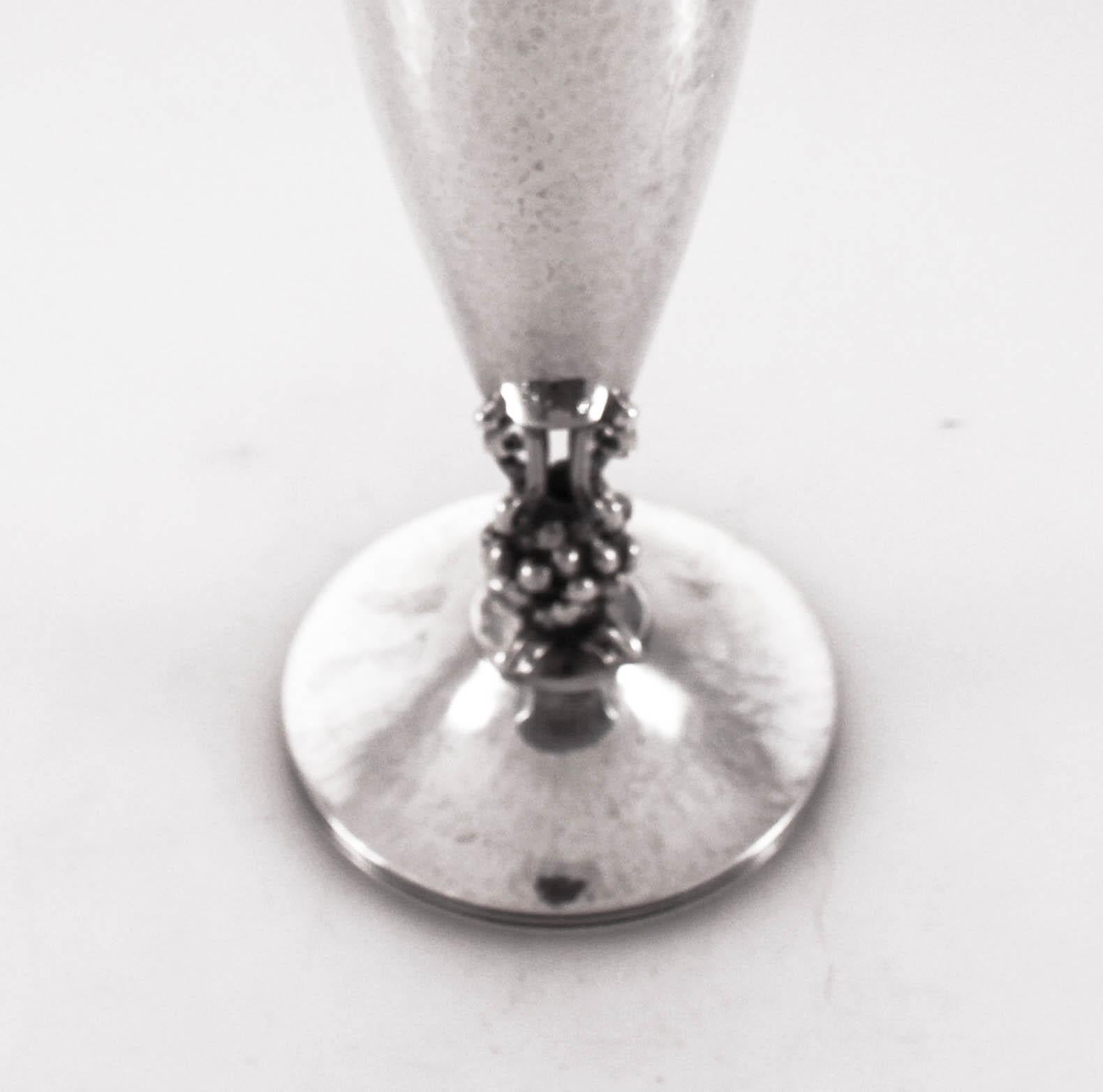 We are proud to offer this sterling silver Danish vase. Hand-hammered and not weighted. It has a beautiful curved oval shape - wider in the center and tailored on top and bottom. Between the base and the top part a cluster of balls holds the two