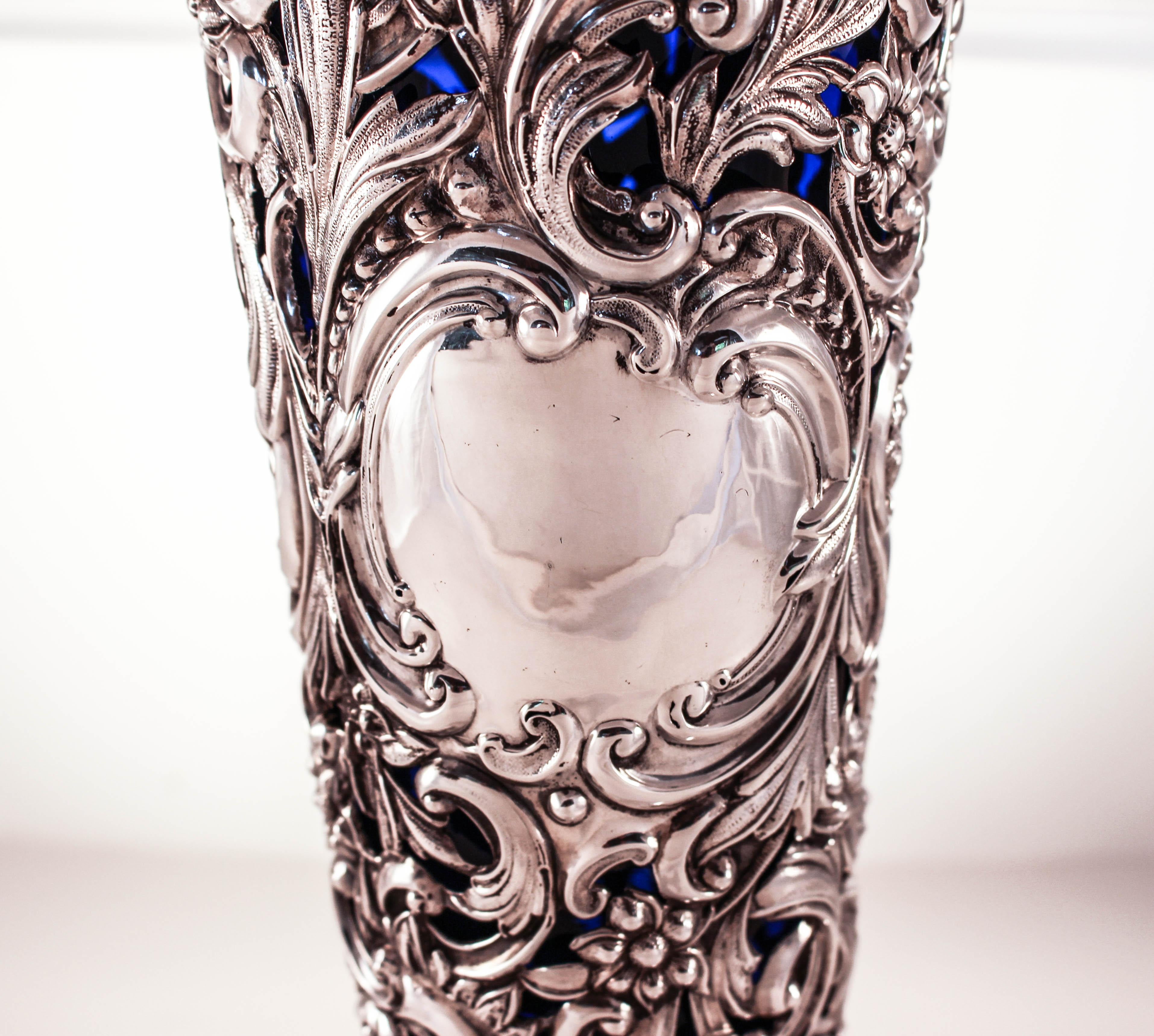 This exceptional sterling silver vase is being offered. It’s very rare to find a vase this size and in this condition. It’s a feast for the eyes; cutout work allows the cobalt to shine through and when the light or sun is in it, it twinkles and