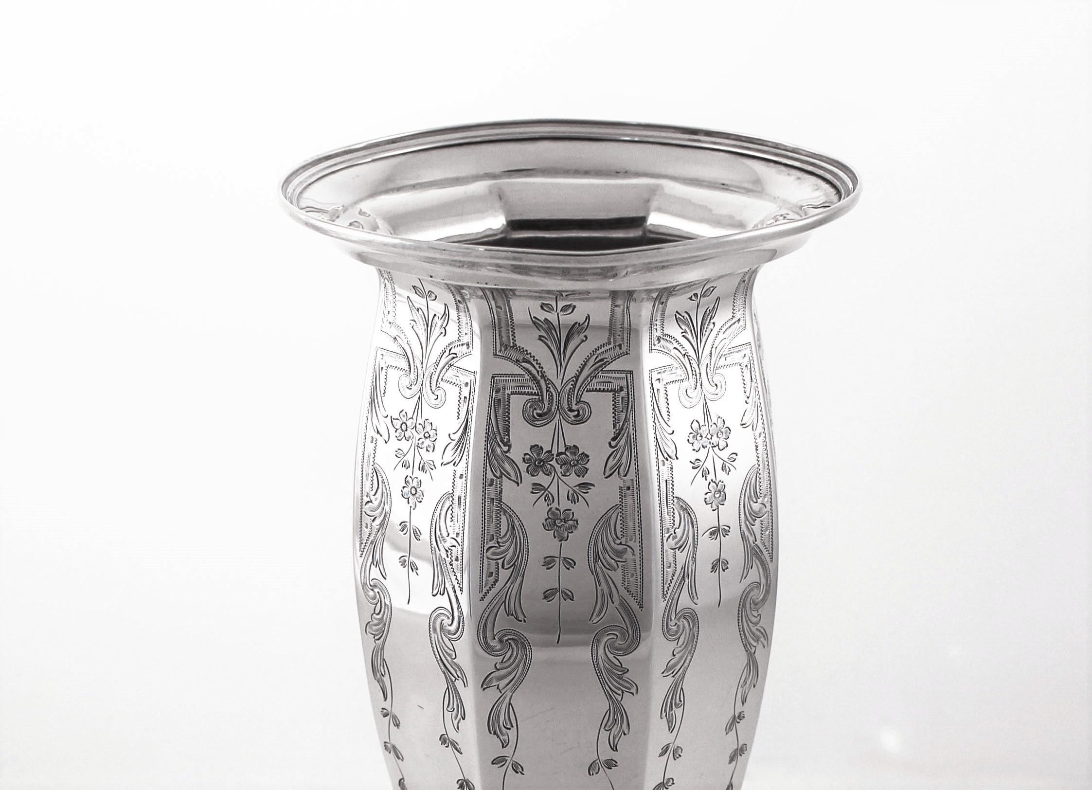 We are thrilled to offer this sterling silver vase by the Watson Silver Company of Massachusetts. It is round in shape but also has paneling and a tailored body; wider on top and narrower on bottom. Starting on top and going towards the base are