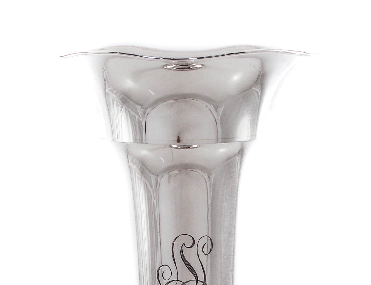 We are happy to offer this sterling silver vase by the Matthews Silver Company of Newark, NJ. It has a sleek and contemporary look; no etchings or decoration. The top is fluted and the body has a tailored shape. There’s a beautiful hand engraved
