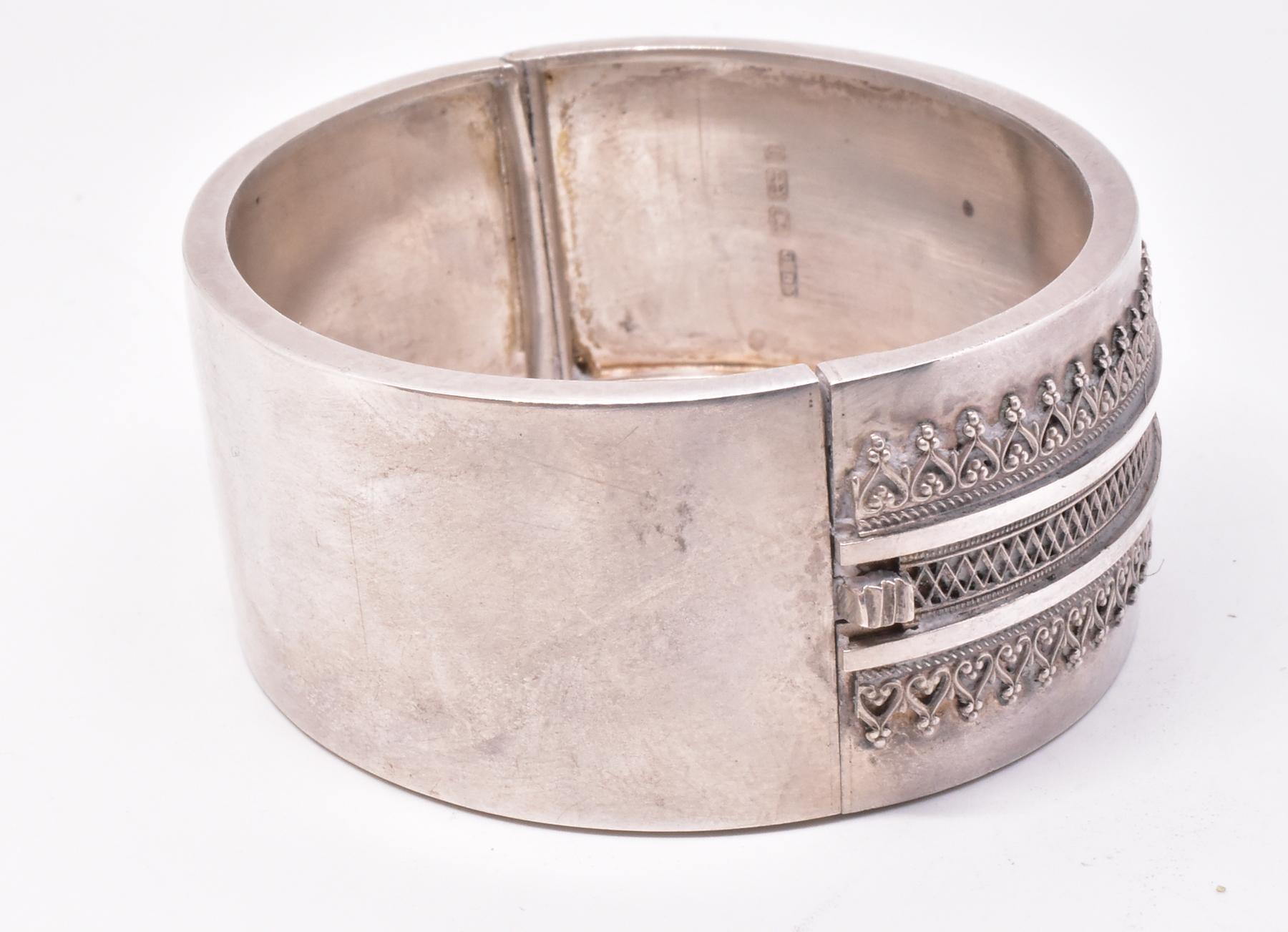 Classical Victorian hallmarked bangle bracelet with three rows of tiny fleurons and X shaped patterns running horizontally across the bangle with reeding in between. Our bracelet is hallmarked 1883 Birmingham and is in pristine condition. It is