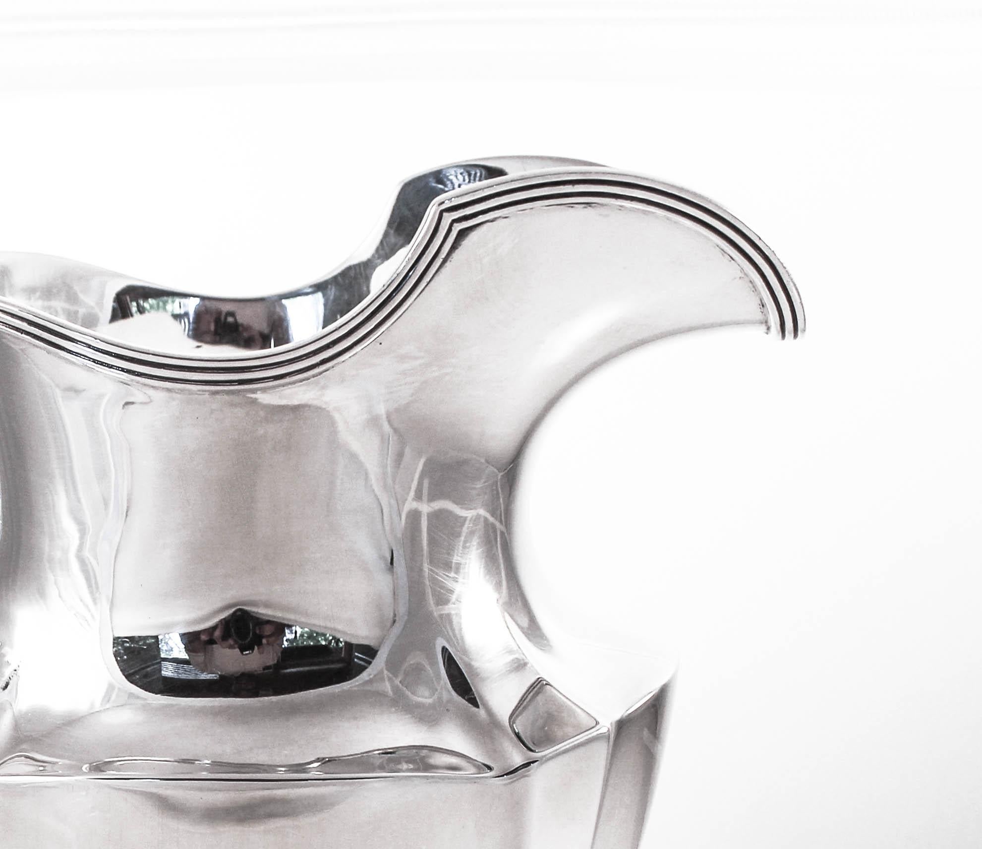 We are pleased to offer this sterling silver water pitcher from 1912 (signed) by the Gorham Silver Co., of Providence Rhode Island. At 108 years old this water pitcher has seen 18 American presidents, the Great Depression, the civil rights movement