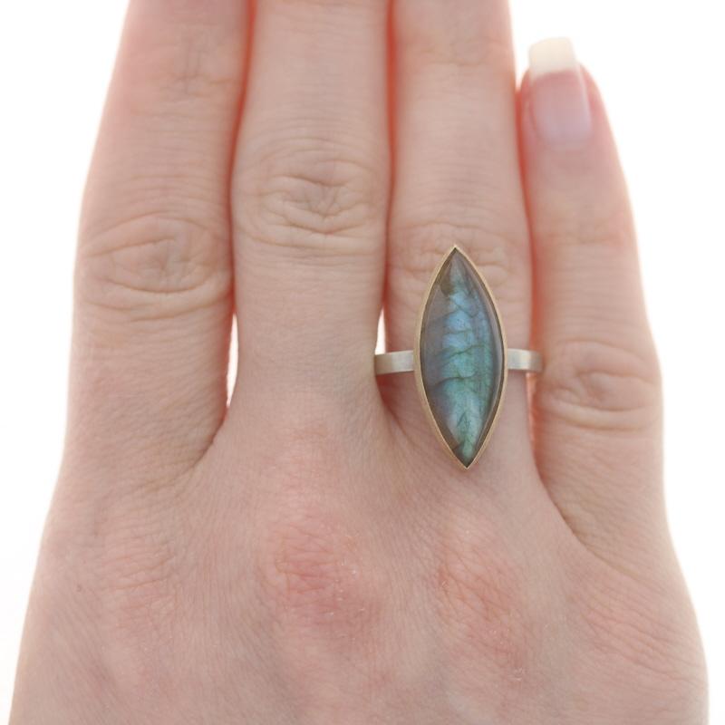 Size: 7
Sizing Fee: Up 1 size for $30

Metal Content: Sterling Silver & 14k Yellow Gold

Stone Information

Natural Labradorite
Cut: Marquise Cabochon

Style: Cocktail Solitaire
Features: Brushed & Smooth Finishes

Measurements

Face Height (north