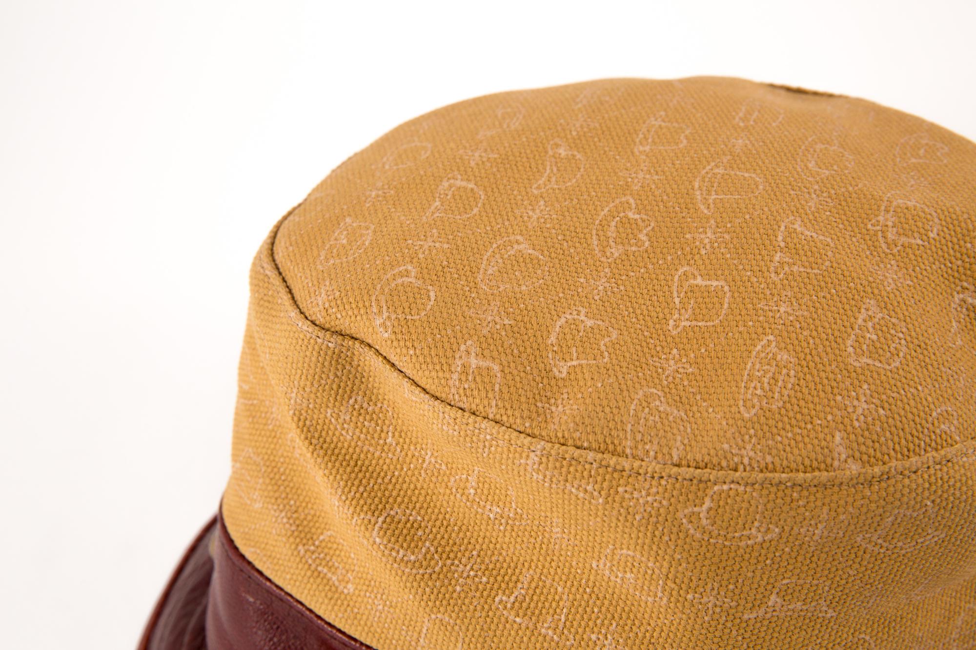 Stetson bucket hat featuring a bordeaux leather border, a camel printed canvas, tarnish gold studs details and a silk lining. 
Printed Label Stetson
Label size:M
Diameter: 21.25in. (54cm)
In excellent vintage condition.  Made in Germany.
We